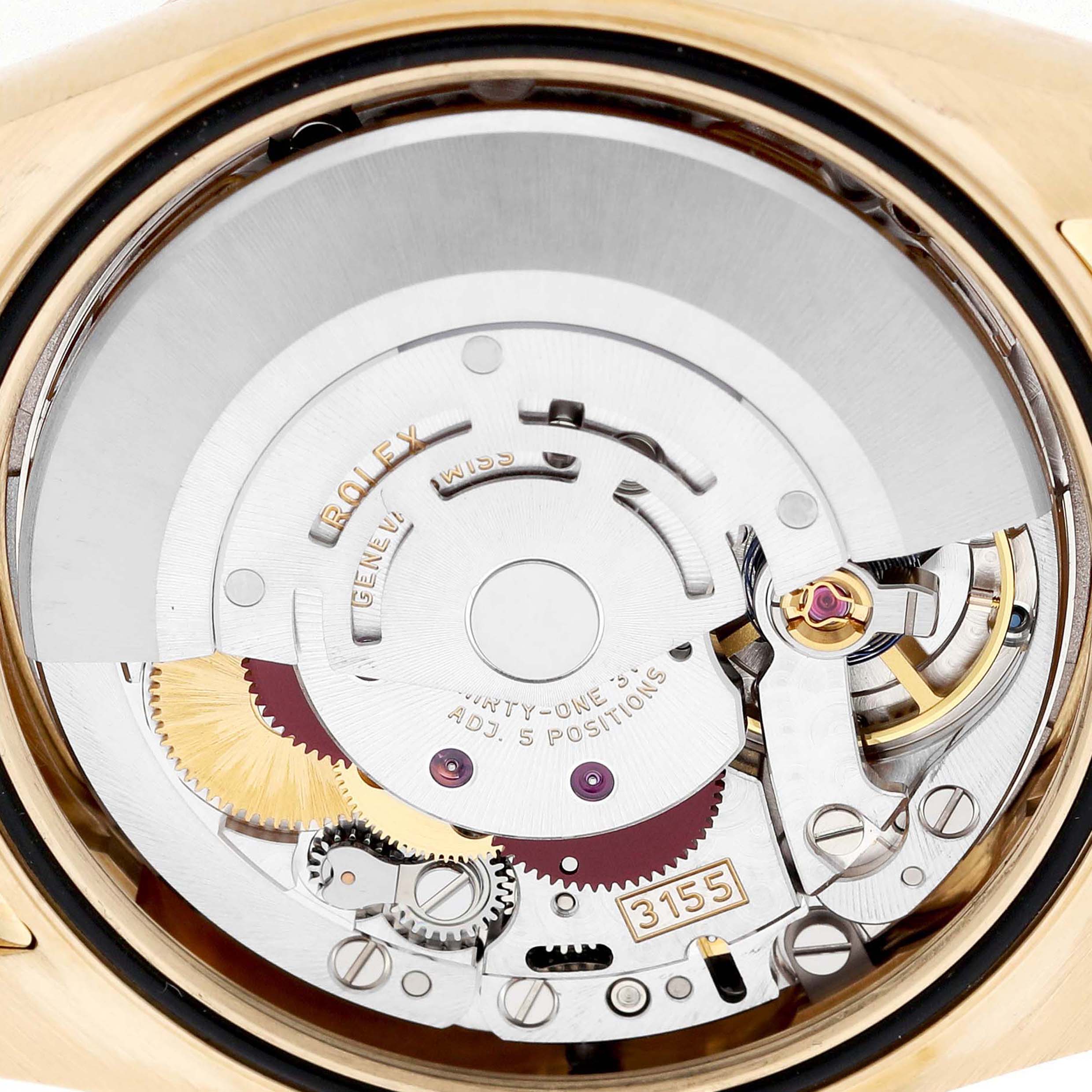 The image shows the Rolex President 118138 Men's Yellow Gold Orange Dial model's movement from the back, highlighting gears, rotors, and intricate mechanical parts.