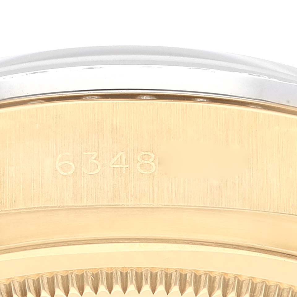 This image shows the side part of a Rolex President 18048 Men's Yellow Gold Champagne Dial 18048 Men's Yellow Gold Champagne Dial model watch, highlighting the serial number engraving.