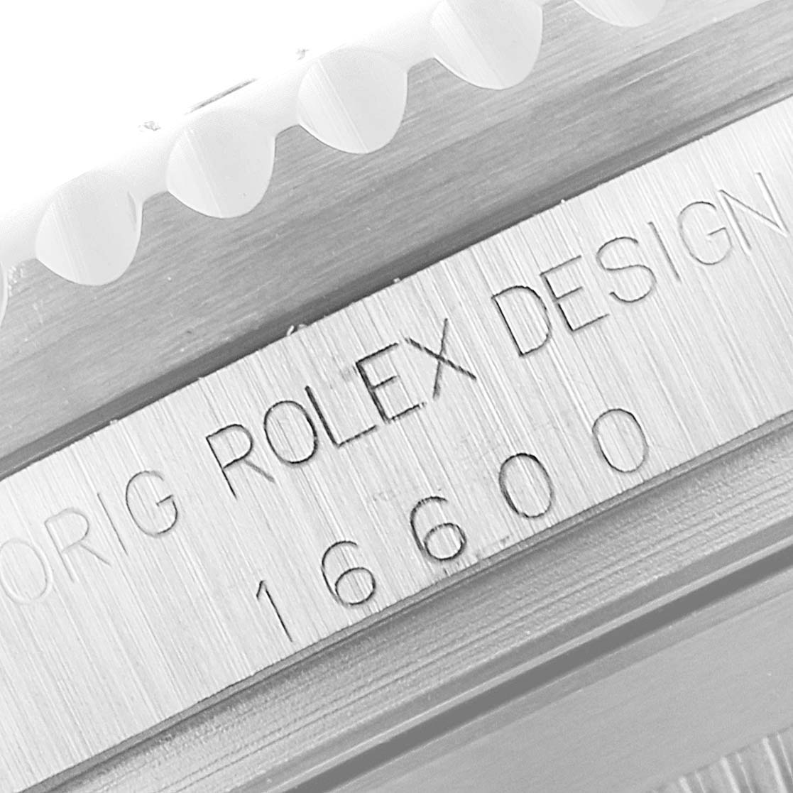 The image shows a close-up of the engraved case edge of a Rolex Sea-Dweller 16600 Men
s Stainless Steel Black Dial 16600 Men
s Stainless Steel Black Dial 16600.