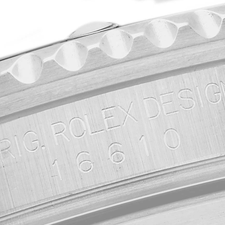The image shows a close-up of the engraved edge of a Rolex Submariner model 16610, highlighting the brand inscription and model number on the bezel side.