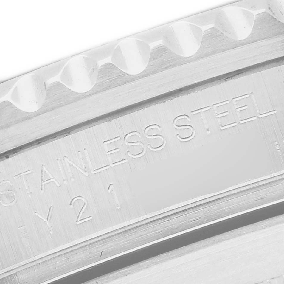 The image shows a close-up of the engraved stainless steel markings on the side of a Rolex Submariner model 16610 men's watch.