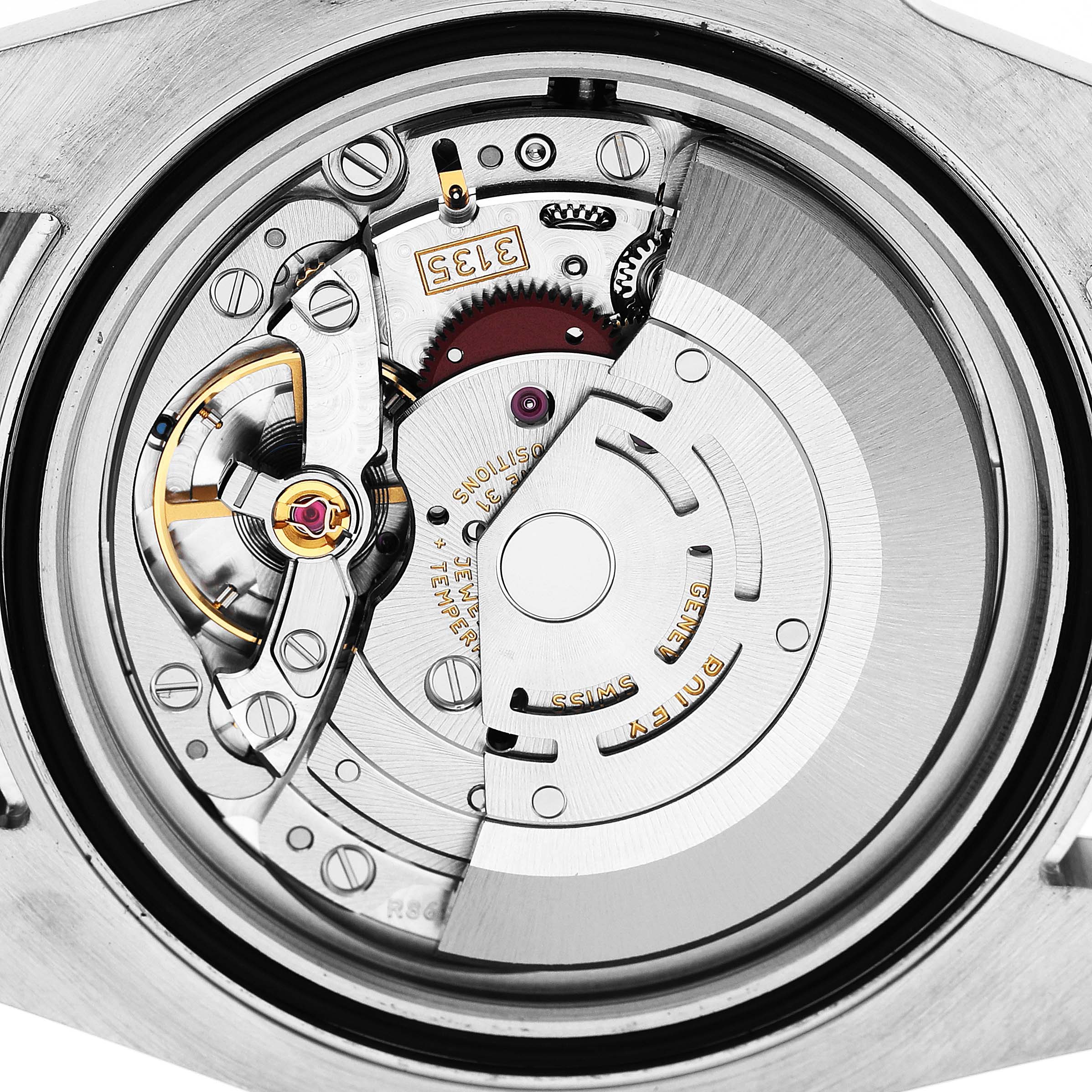 The image shows the intricate movement mechanism of a Rolex Submariner M116610LN-0001 Men's Stainless Steel Black Dial, viewed from the back, displaying gears and components.