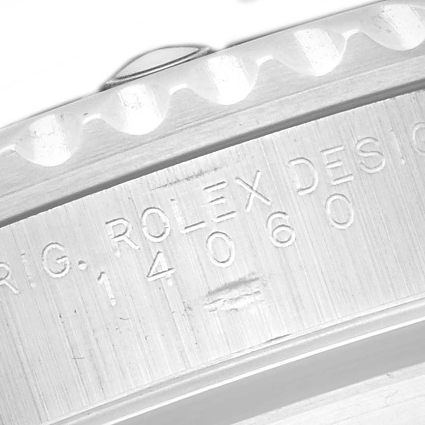 The image shows an angled close-up of the side edge of a Rolex Submariner watch, model number 14060, highlighting the engraved branding and design number.