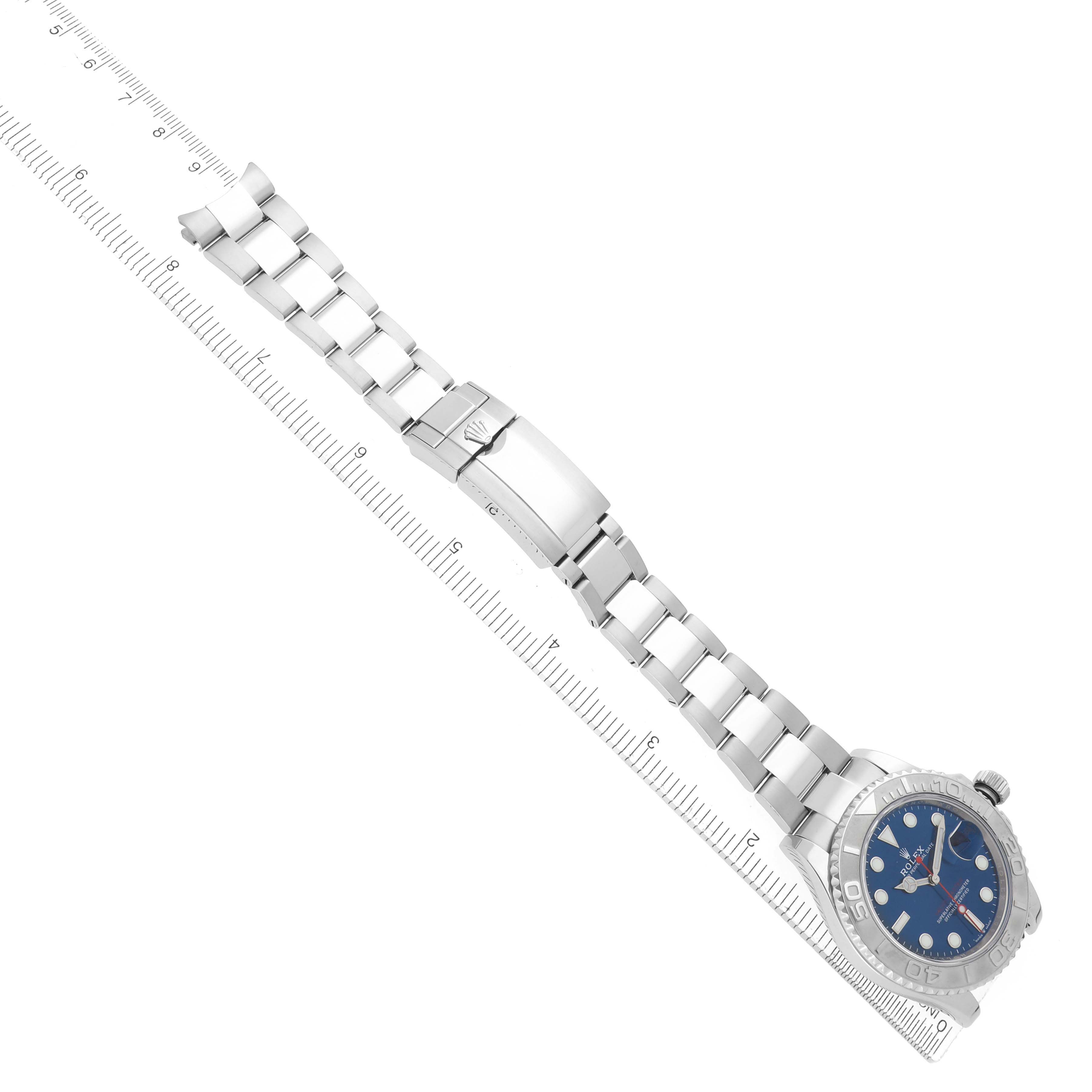 The image shows a Rolex Yacht-Master model 126622 men's watch laid flat, showcasing the bracelet, clasp, and blue dial with a side view of the bezel and crown.