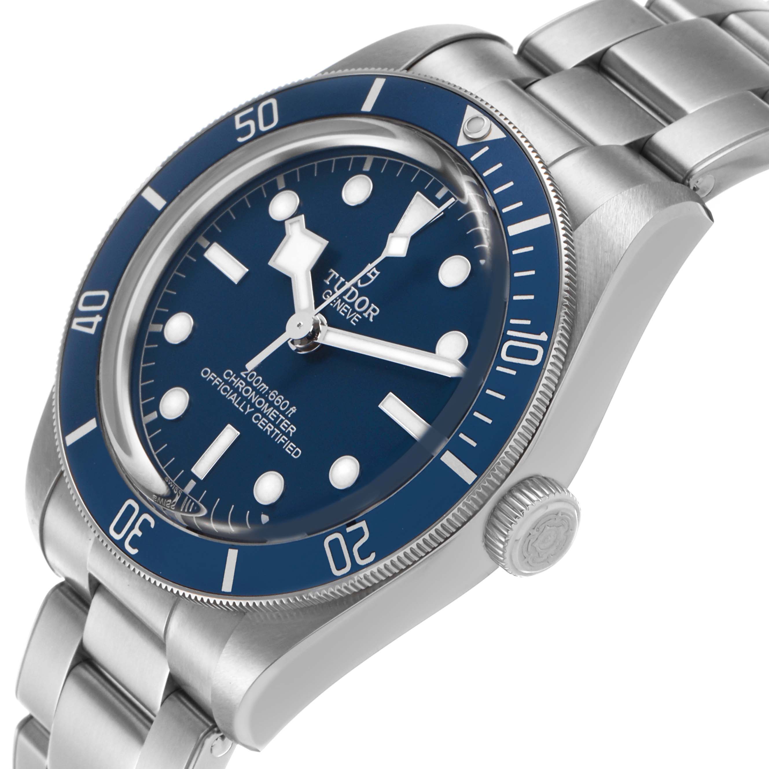 The Tudor Heritage Black Bay 79030B Men's Stainless Steel Blue Dial watch is shown at an angle highlighting the bezel, crown, dial, and part of the bracelet.