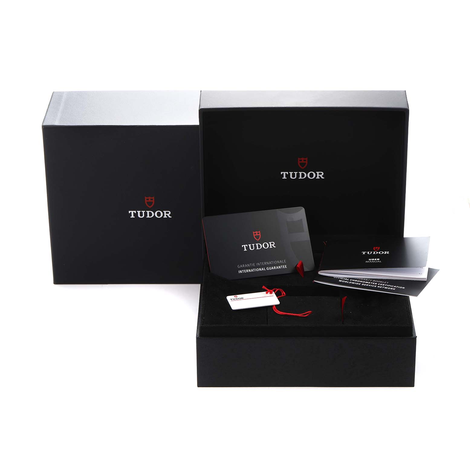 The image shows packaging and accessories for the Tudor Heritage Black Bay model 79000, including a box, warranty card, and booklets, viewed from the front.