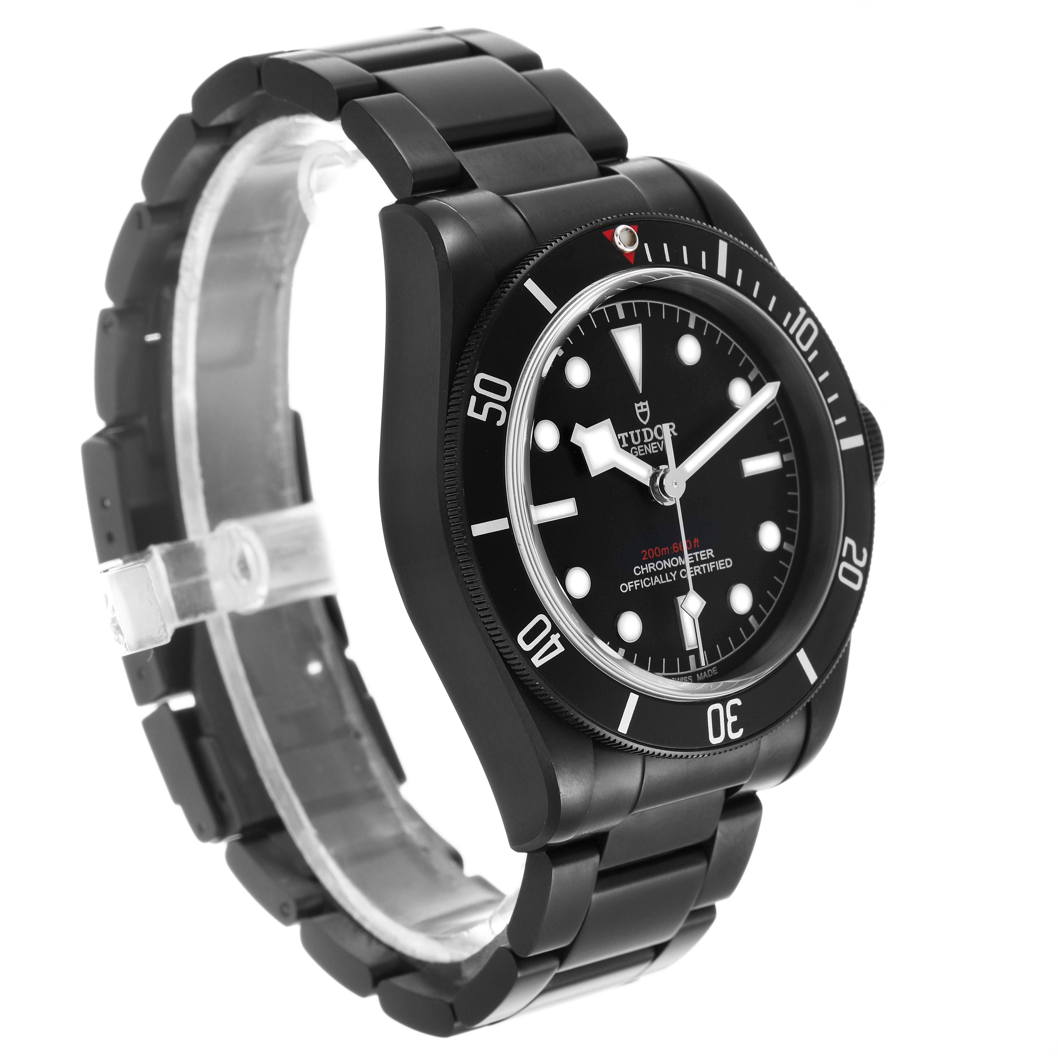 The image shows a Tudor Heritage Black Bay 79230DK Men's Stainless Steel Black Dial watch at a slight side angle, highlighting the watch face, bezel, and metal bracelet.