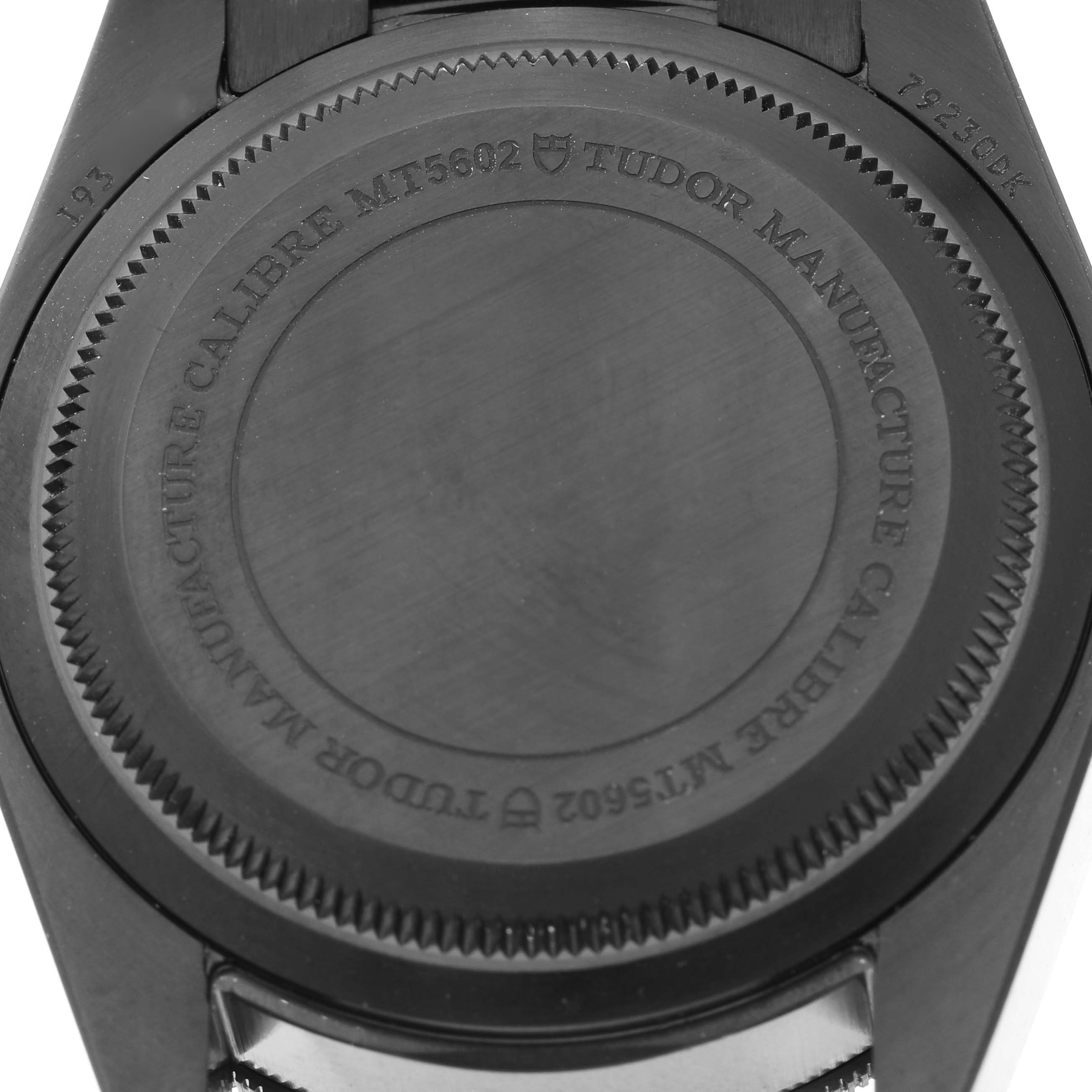 The image shows the back case of the Tudor Heritage Black Bay 79230DK Men's Stainless Steel Black Dial watch, focusing on the engraved details.