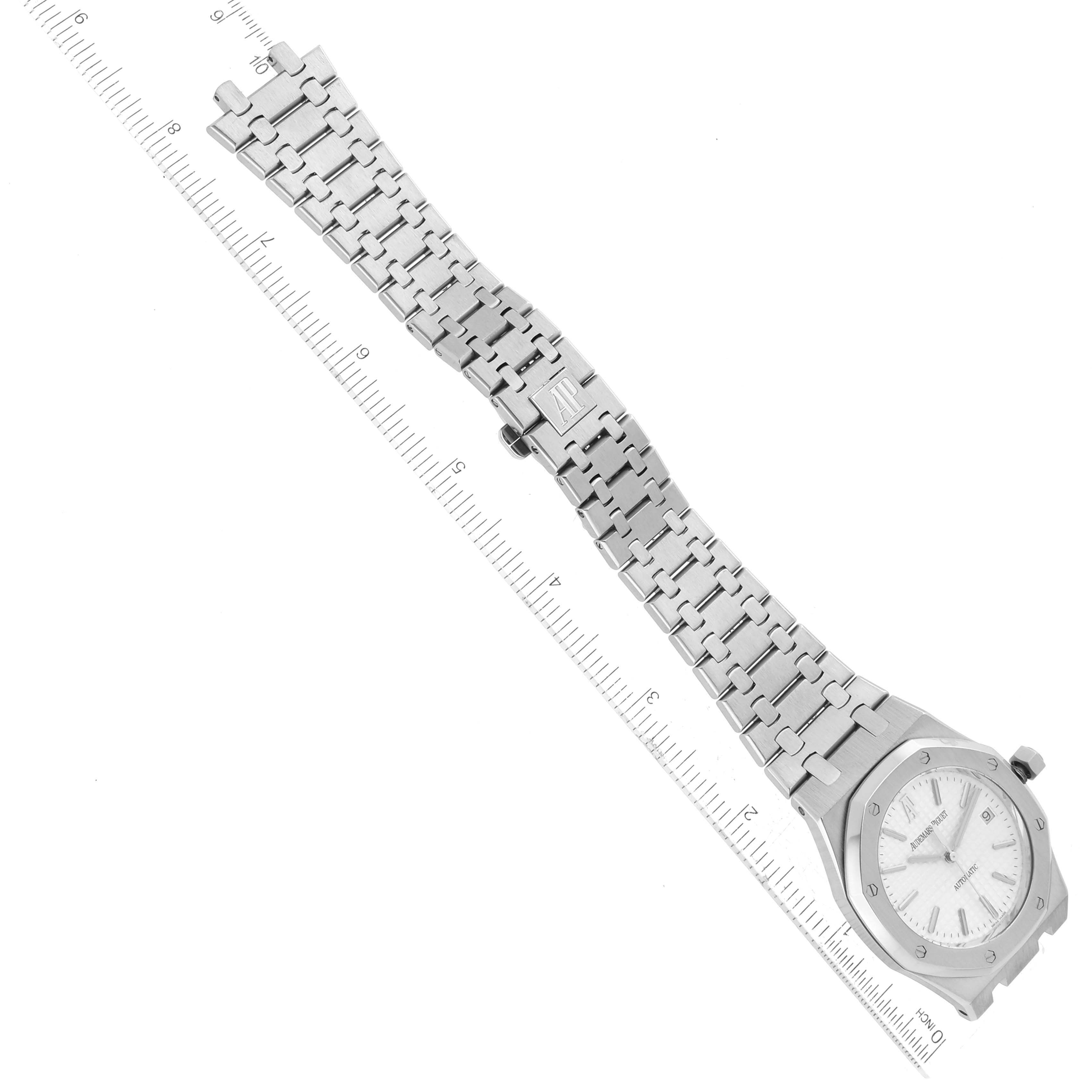 The image shows the Audemars Piguet Royal Oak 15300ST.00.1220ST.01 Men's Stainless Steel White Dial 15300ST.00.1220ST.01 Men's Stainless Steel White Dial watch at an angle, displaying the watch face and stainless steel bracelet alongside a ruler.