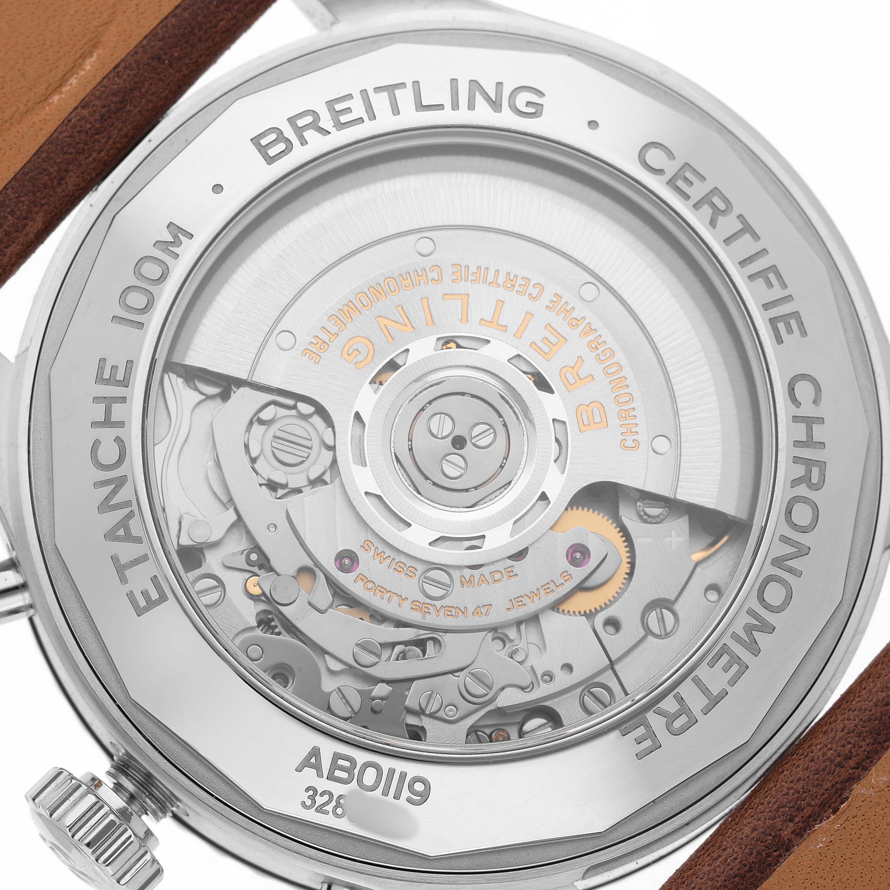 The image shows the back view of the Breitling Aviator AB0119 Men's Stainless Steel Black Dial watch, highlighting the intricate movement and engraving details.