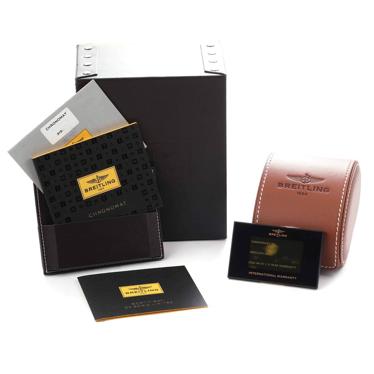 The image shows accessories for a Breitling Chronomat watch, model number AB0111, including boxes, a certificate, warranty card, and instruction booklet.