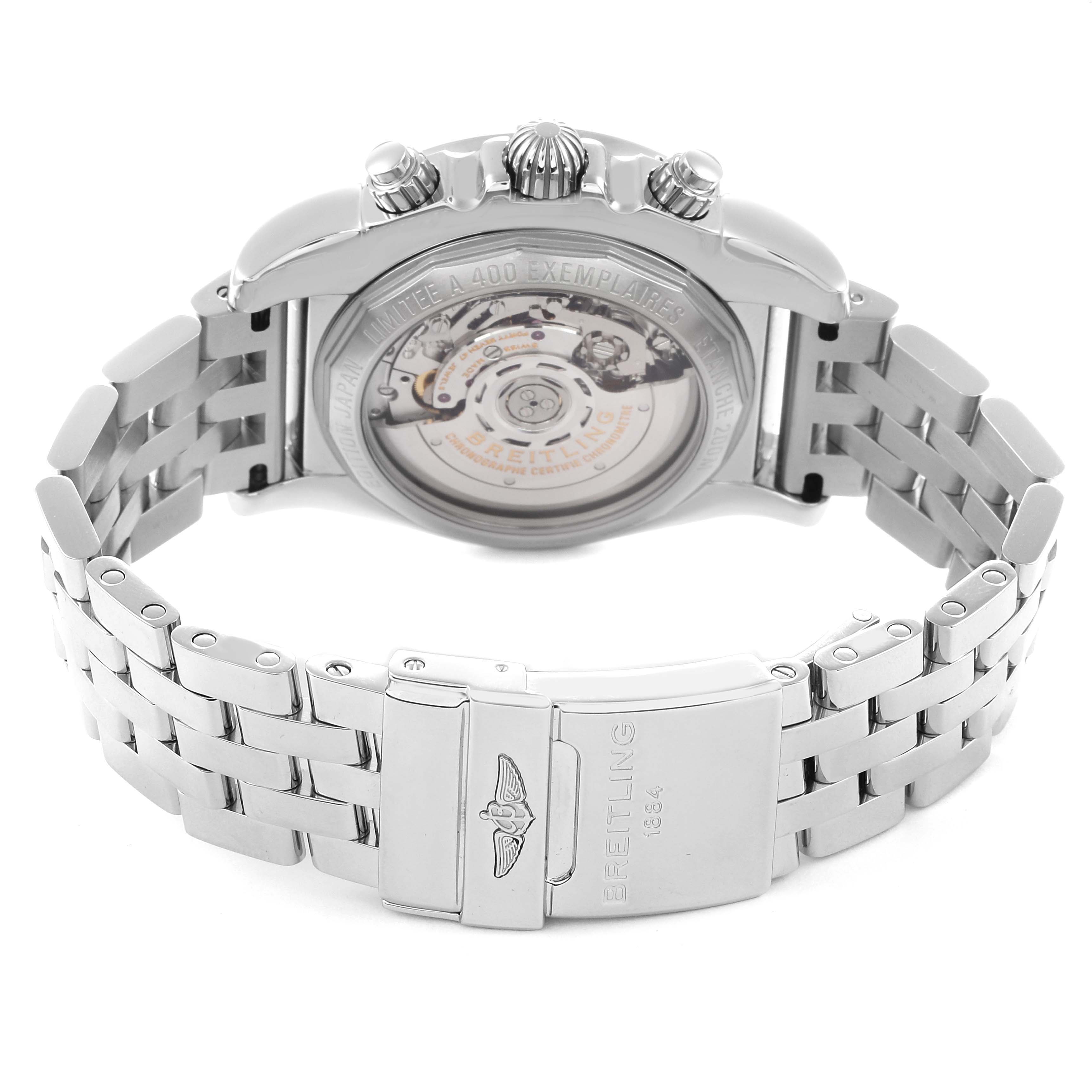 The image shows the back view of a Breitling Chronomat AB0111 men's watch, highlighting the exhibition case back, crown, pushers, and metal bracelet clasp.