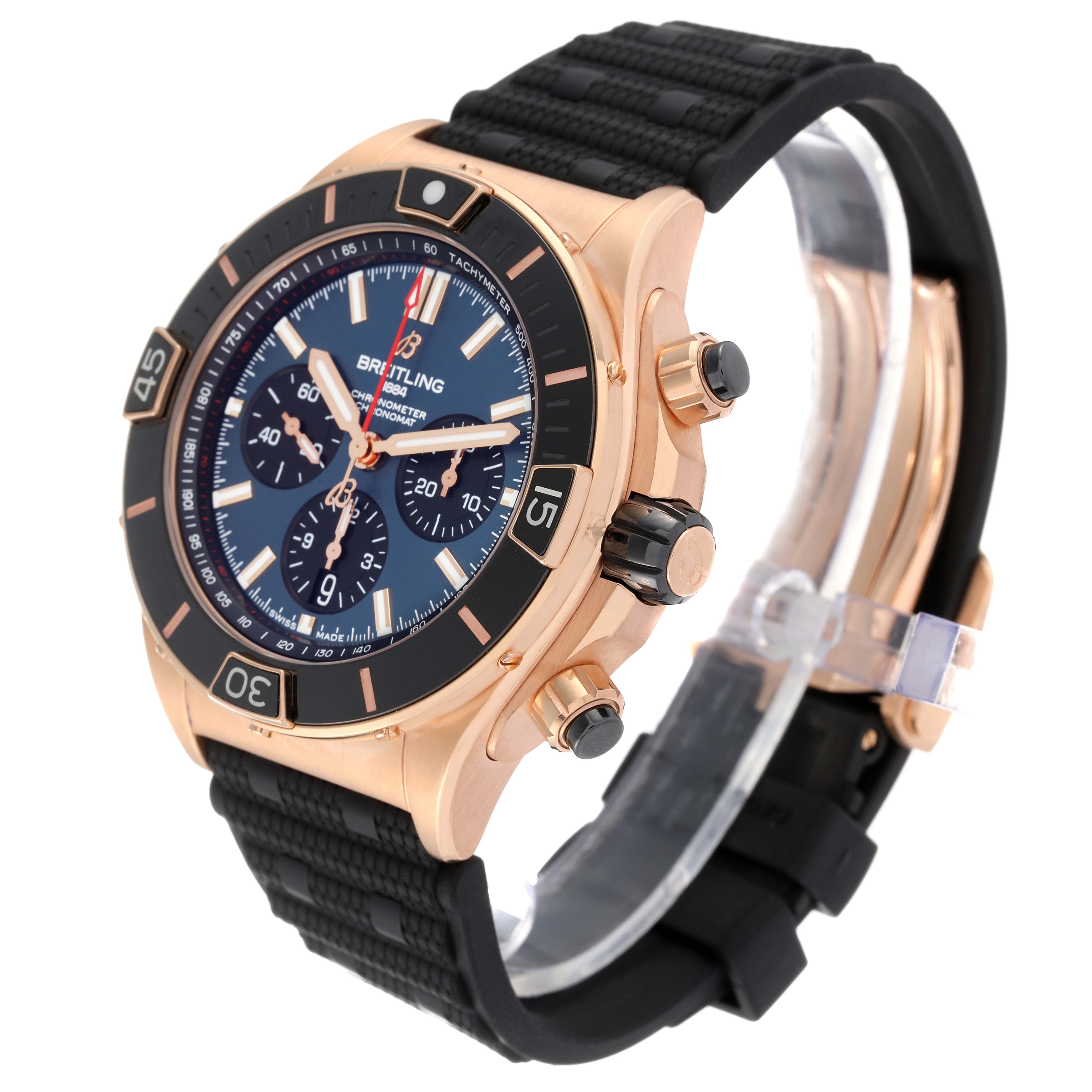 The image shows a Breitling Chronomat RB0136 Men's Rose Gold Blue Dial RB0136 Men's Rose Gold Blue Dial watch at a slight side angle showcasing the face, bezel, crown, and part of the strap.