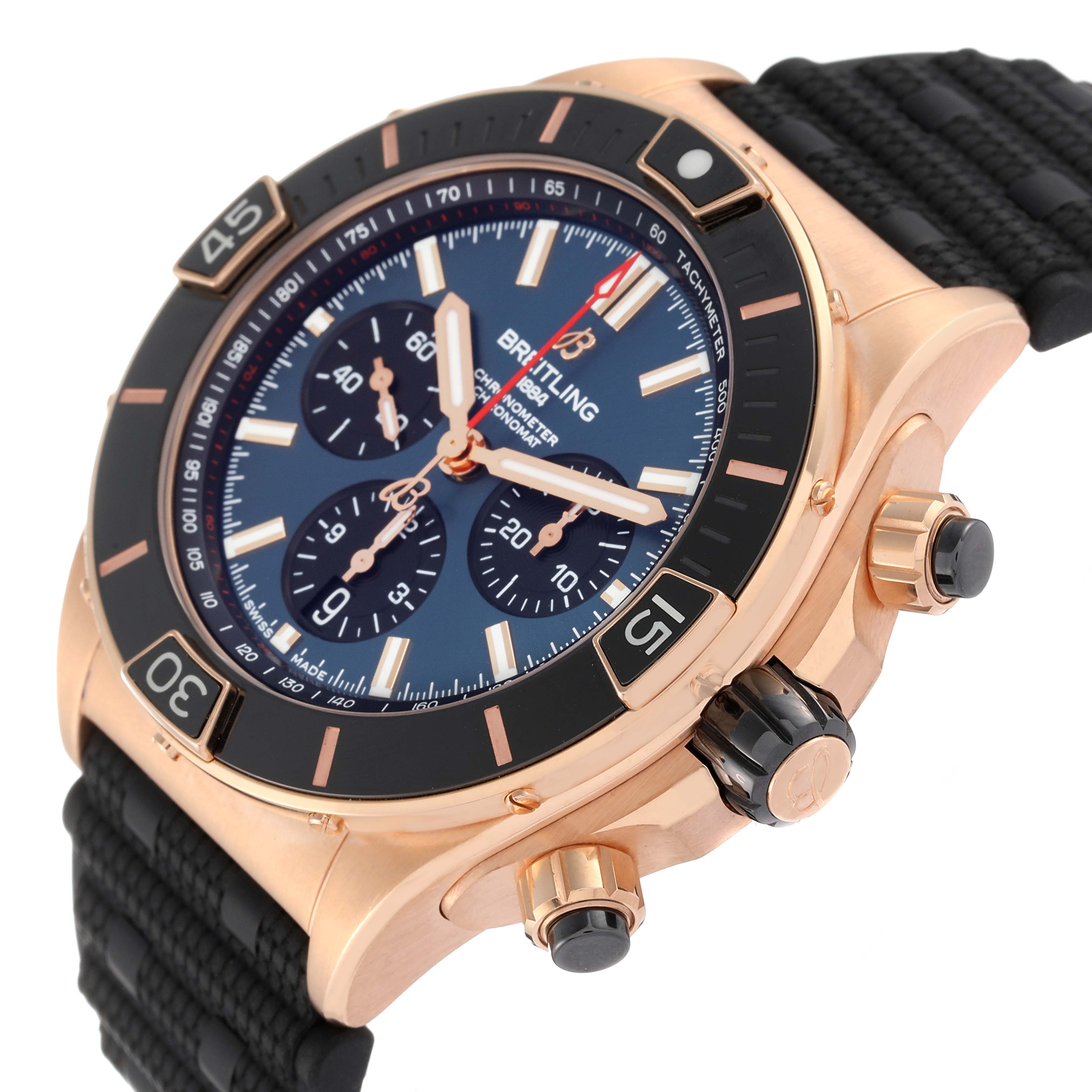 This image shows a side angle view of a Breitling Chronomat RB0136 Men's Rose Gold Blue Dial RB0136 Men's Rose Gold Blue Dial watch, highlighting the face, bezel, crown, and chronograph buttons.