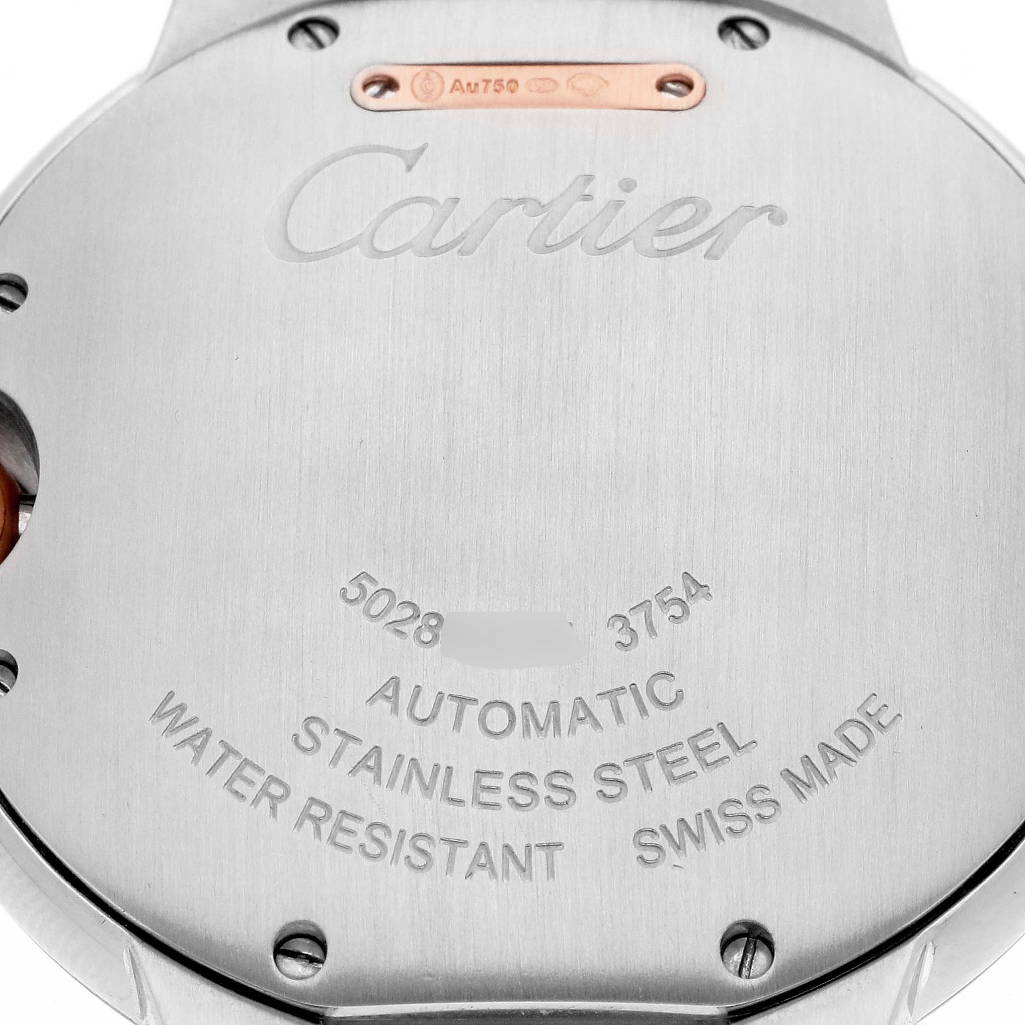The image shows the back case of a Cartier Ballon Bleu W3BB0004 Men's watch, highlighting engraved details like "Cartier," "Automatic," "Stainless Steel," and "Swiss Made."