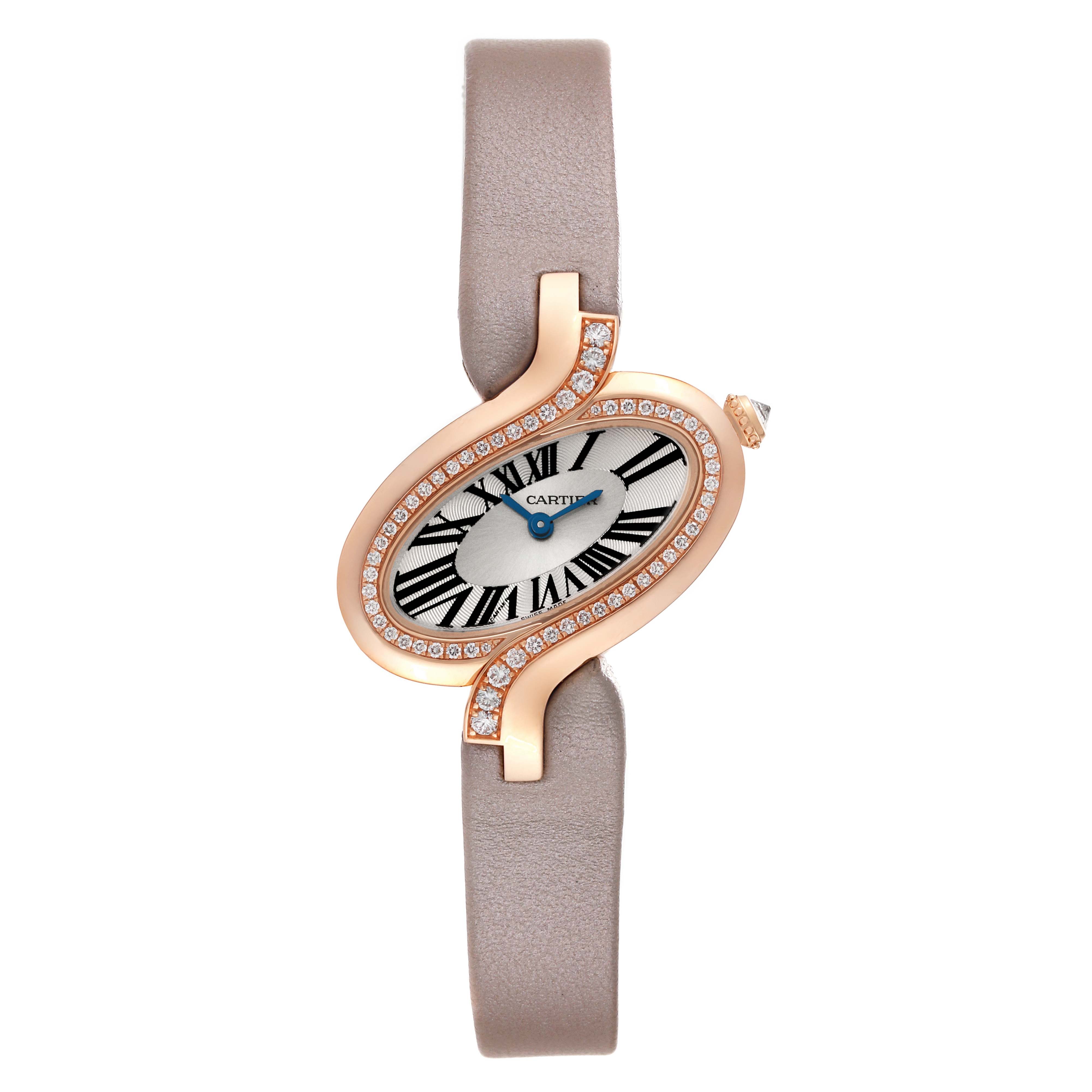 The image shows a Cartier Delices WG800013 Women
s Rose Gold Silver Dial WG800013 Women
s Rose Gold Silver Dial model watch from a front angle, featuring its oval face, leather strap, and diamond-encrusted bezel.