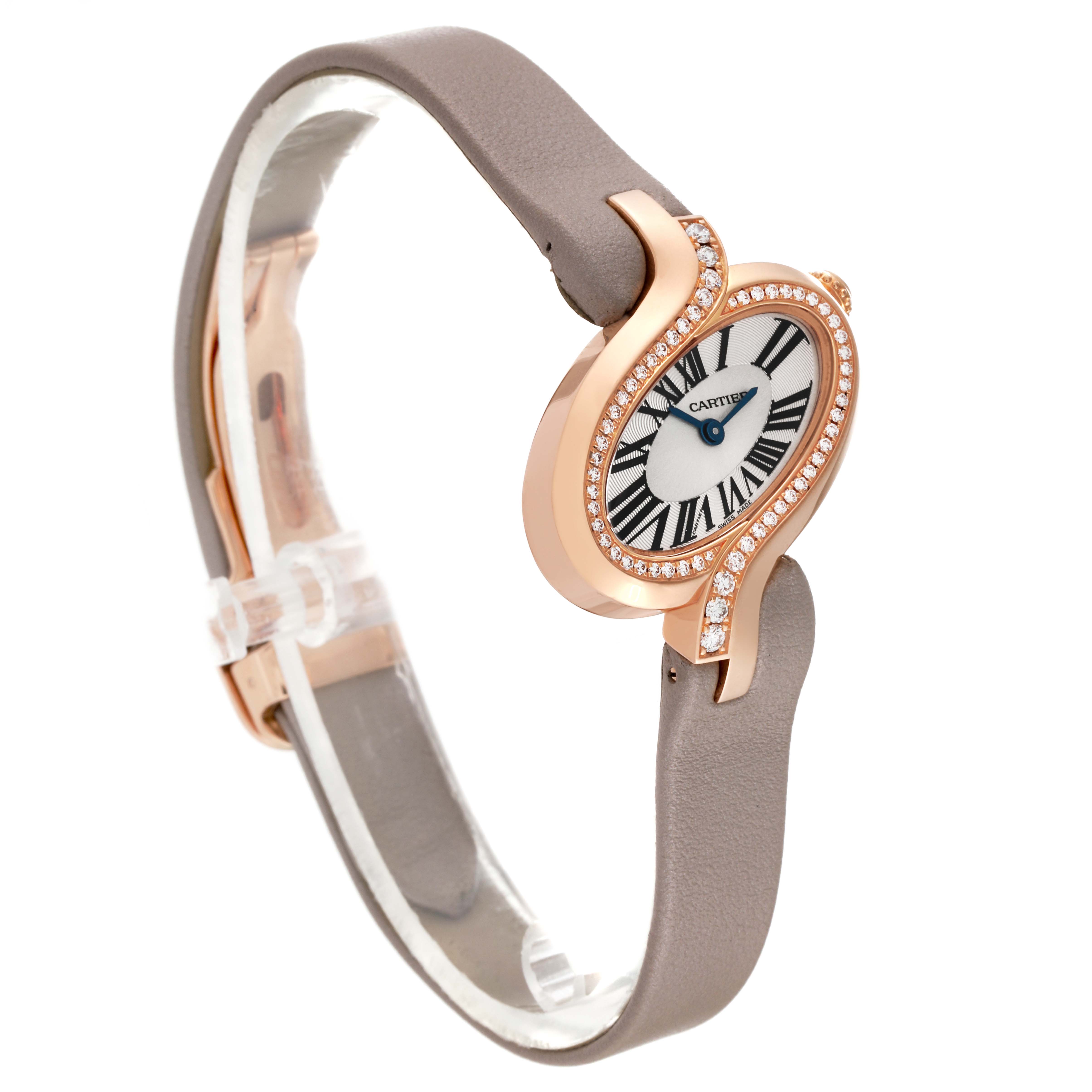 The image shows a side view of a Cartier Delices WG800013 Women
s Rose Gold Silver Dial WG800013 Women
s Rose Gold Silver Dial watch, highlighting its brown strap and diamond-studded, oval-shaped case.