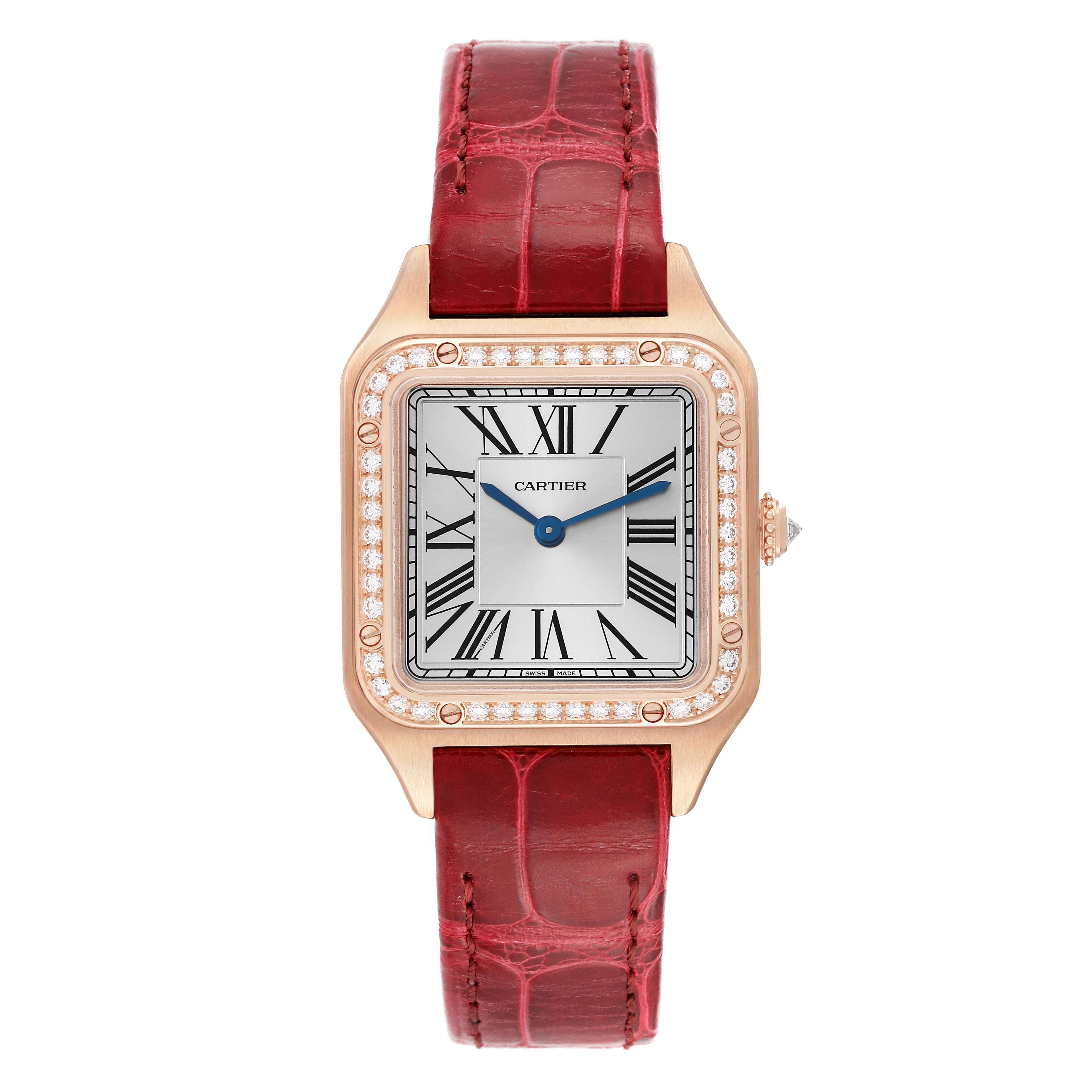 This image shows a front view of a Cartier Santos WJSA0017 Women's Rose Gold Silver Dial WJSA0017 Women's Rose Gold Silver Dial watch with a red strap, gold case, and a diamond-encrusted bezel.