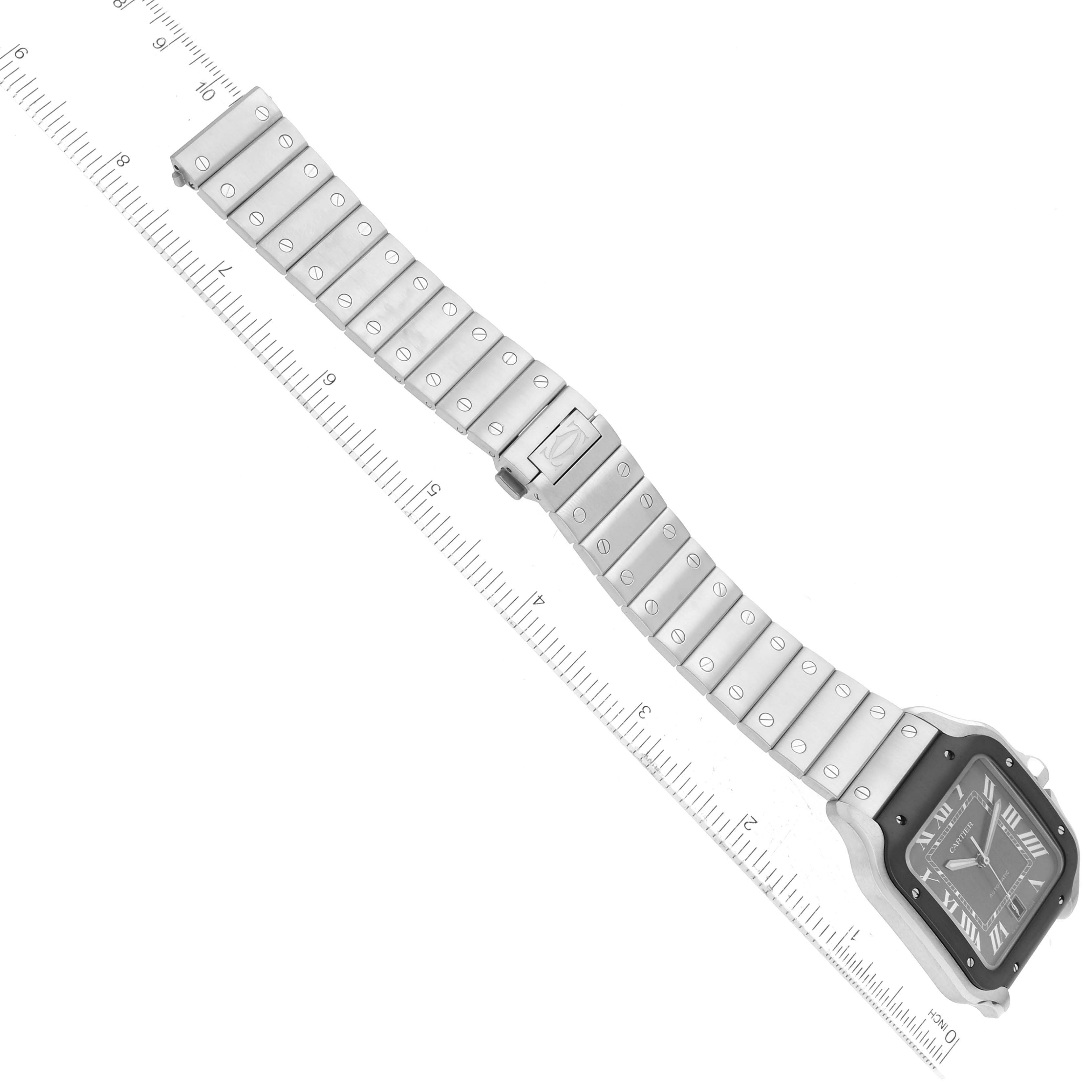 The image shows a Santos model by Cartier watch laid flat for measurement, displaying the watch face, bracelet, and clasp.
