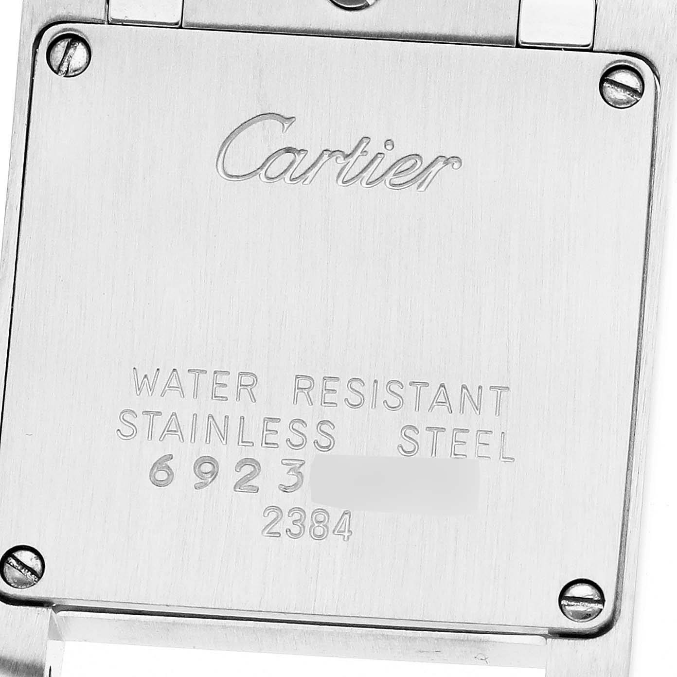 The image shows the back casing of a Cartier Tank Française model W51007Q4, displaying "Cartier," "WATER RESISTANT," "STAINLESS STEEL," and serial numbers.