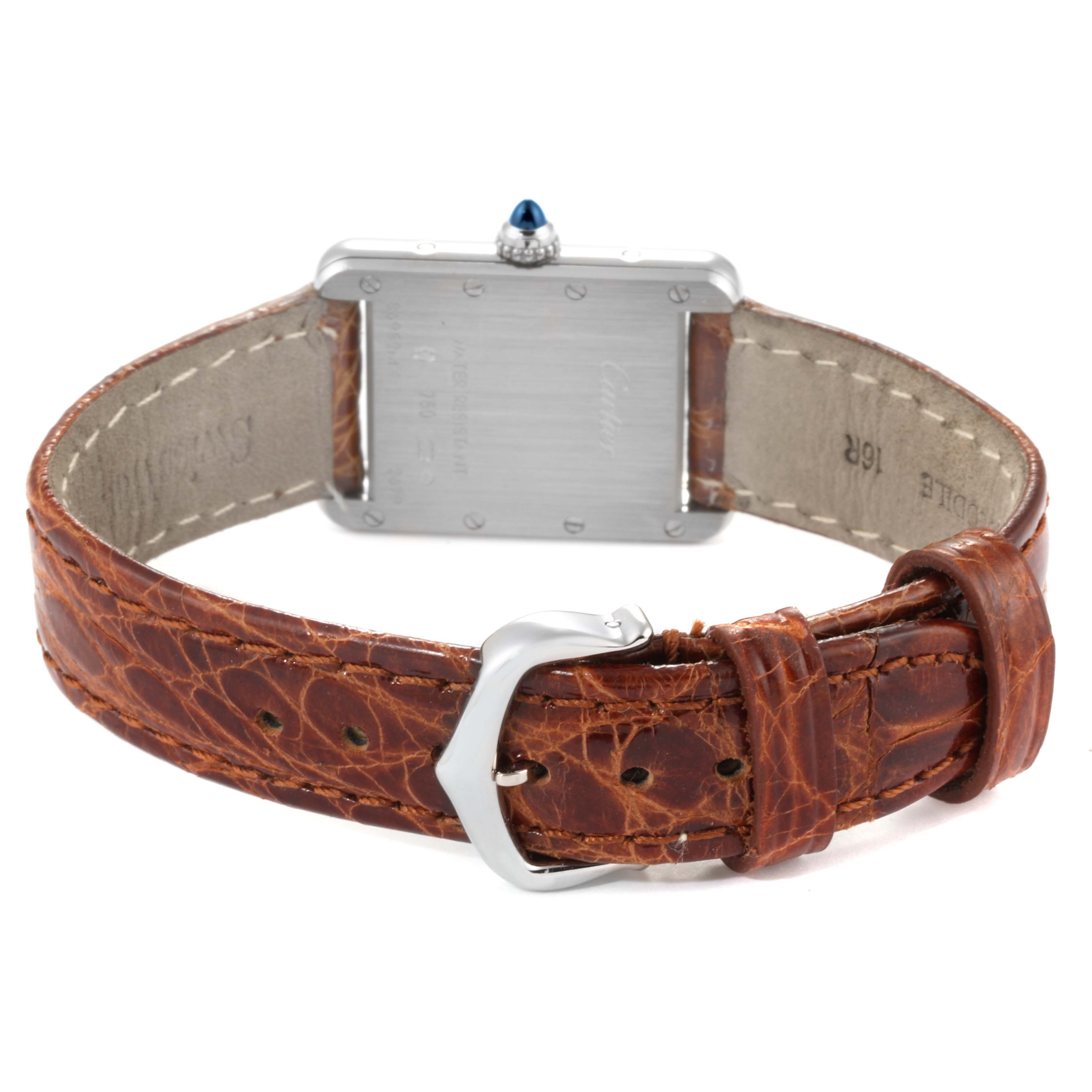 The image shows the back of a Tank Louis model by Cartier and its brown leather strap with a buckle.