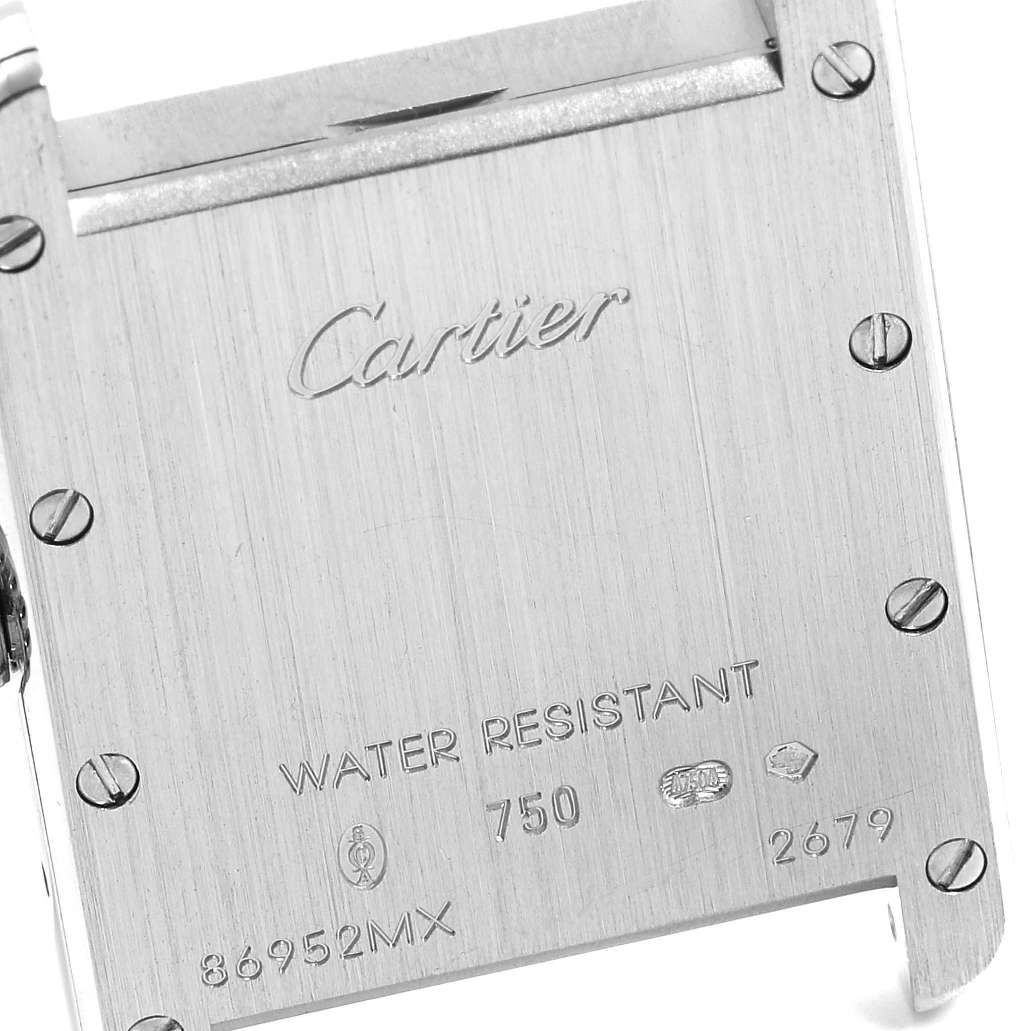 This image shows the back case of a Cartier Tank Louis W1541056 Women
s White Gold Silver Dial W1541056 Women
s White Gold Silver Dial watch, displaying engravings and screws.