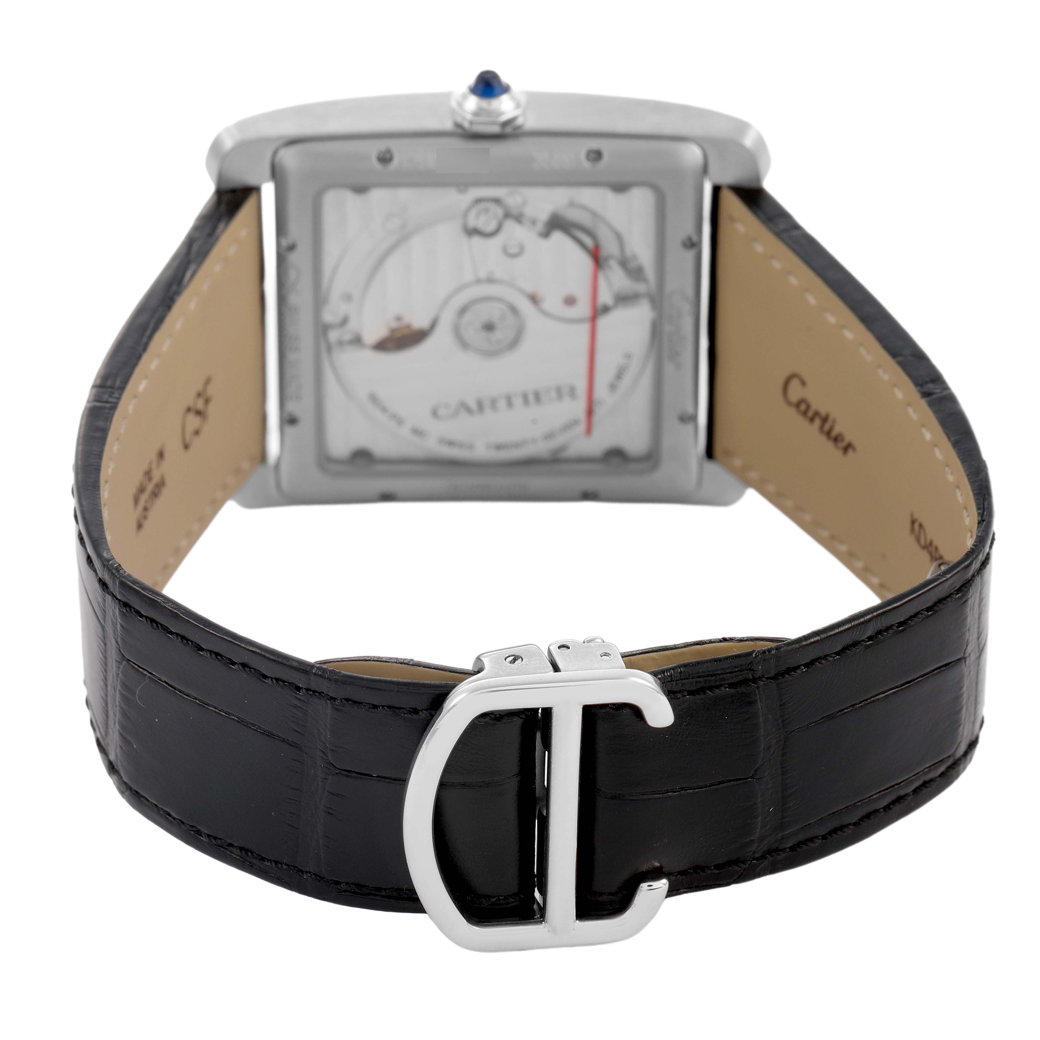 The Cartier Tank MC W5330004 Men's Stainless Steel Black Dial watch is shown from the back, highlighting the movement, leather strap, and deployment buckle.