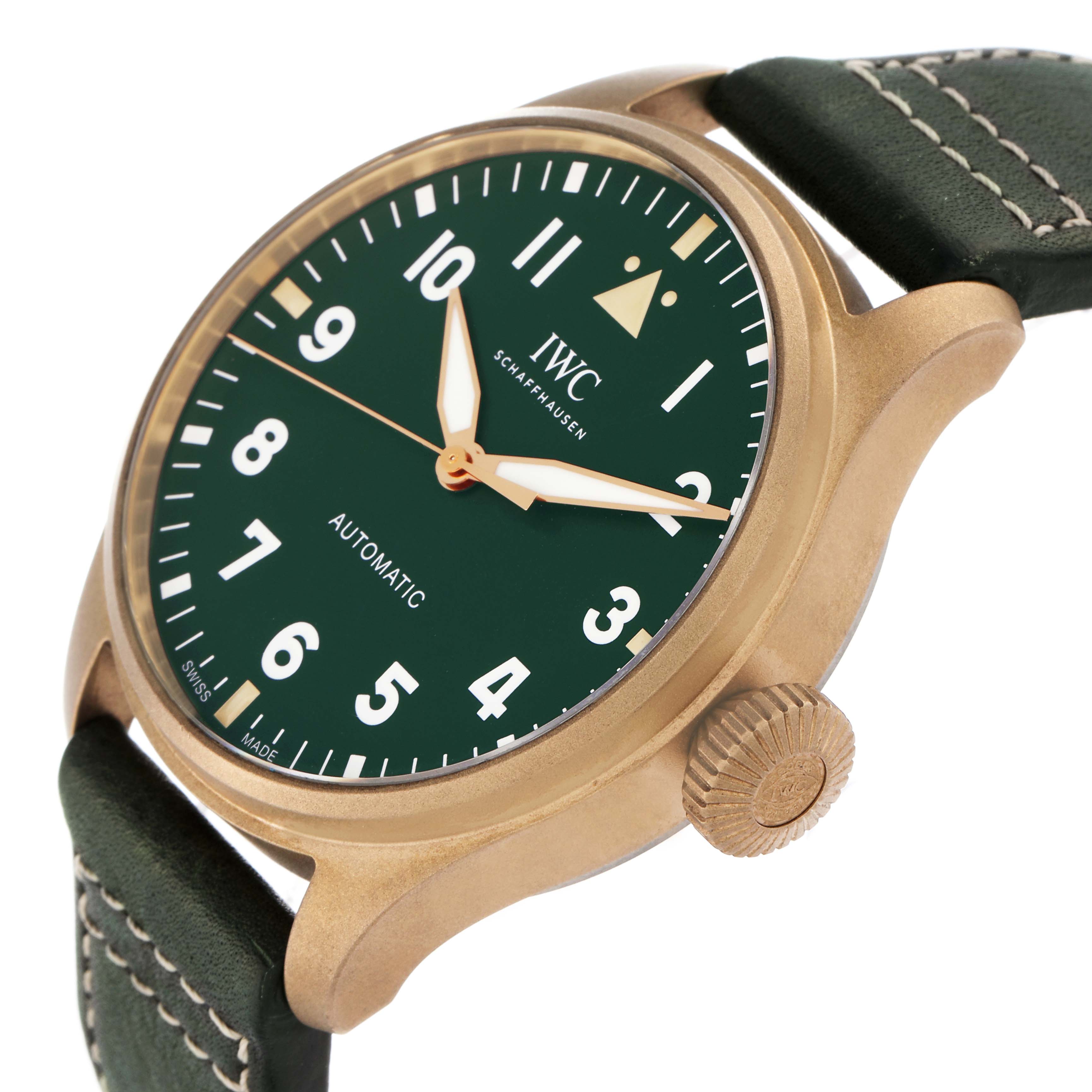 The IWC Pilot model IW329702 is shown from an angled side view, highlighting its green dial, gold-tone case, crown, and stitched leather strap.