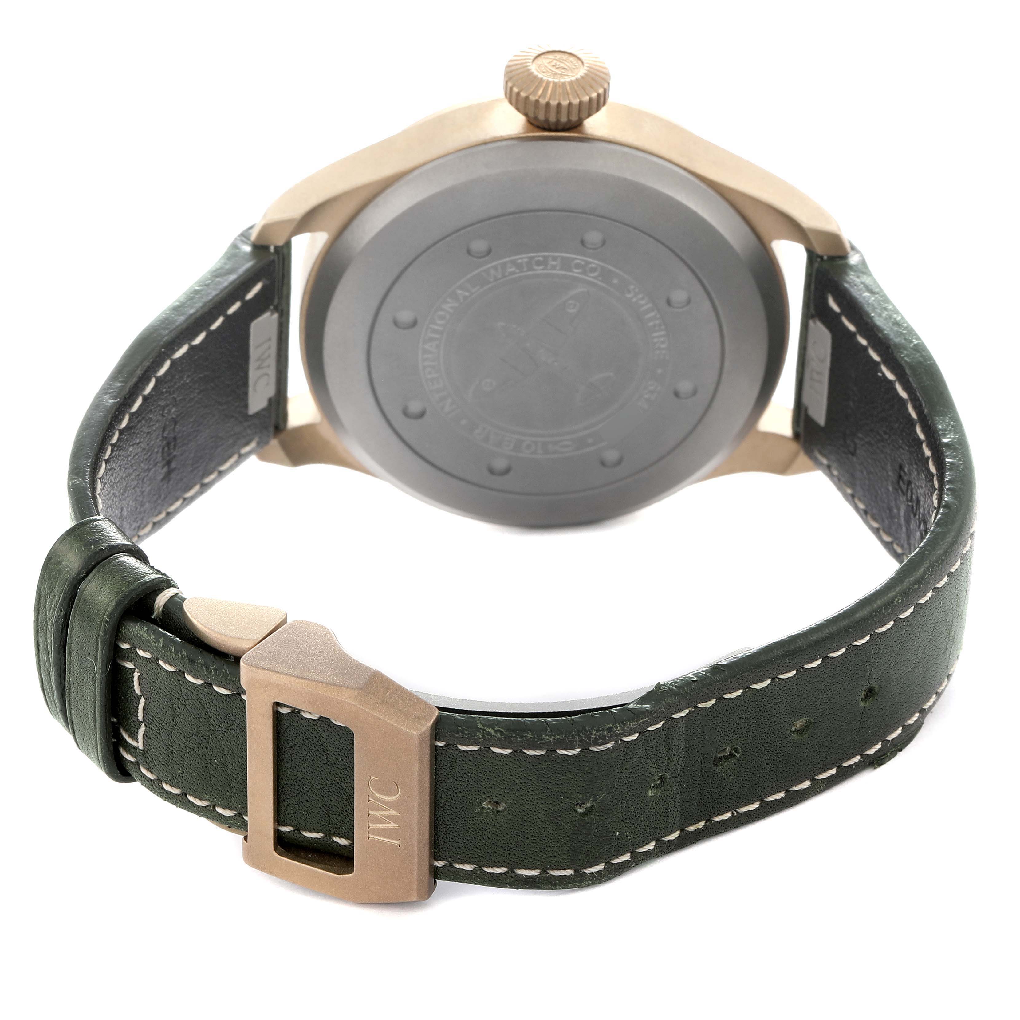 The image shows the back of the IWC Pilot model IW329702 men's watch, highlighting the case back, crown, and leather strap with a buckle.