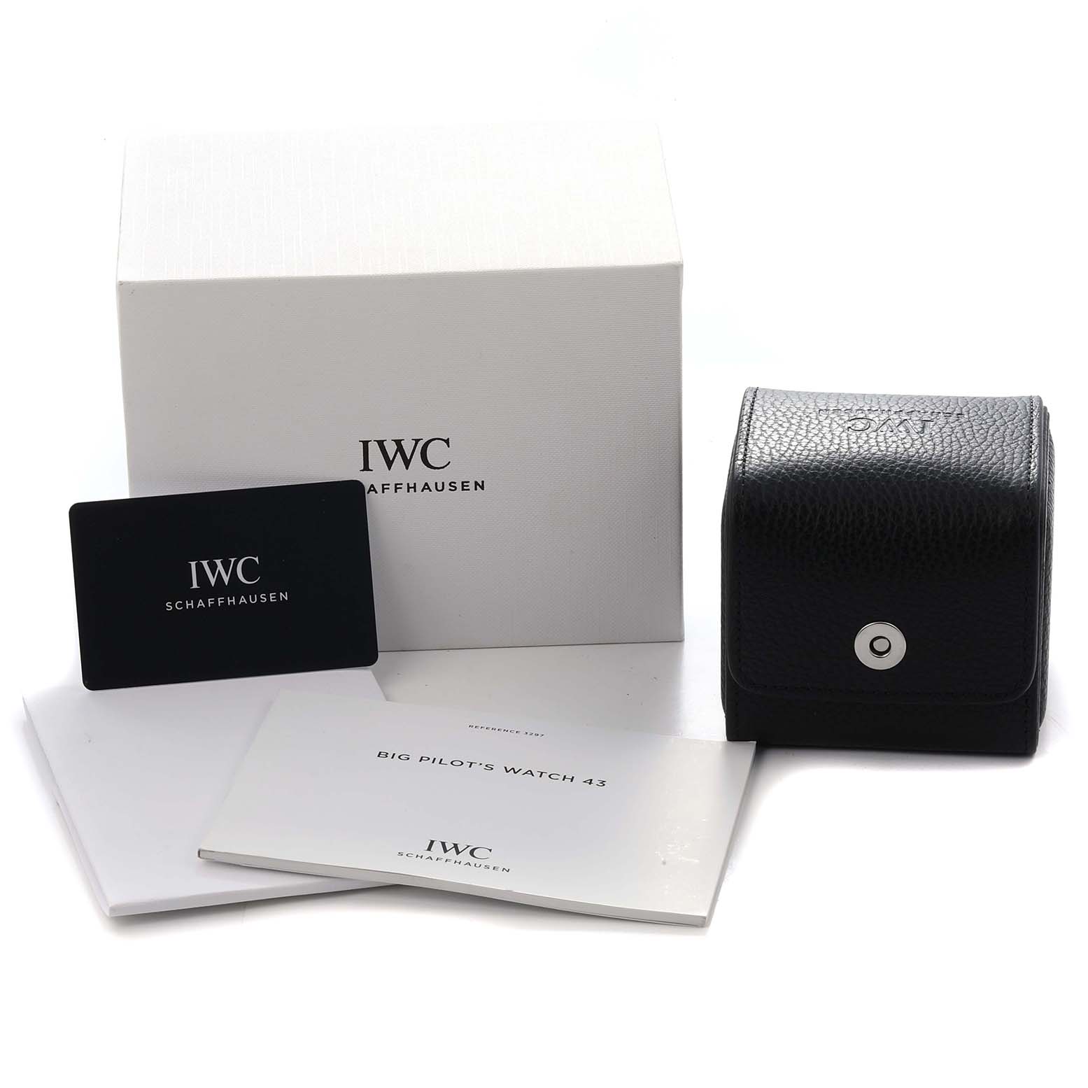 The image shows the IWC Pilot model IW329702 packaging, including a black pouch, a white box with branding, manuals, and a card.