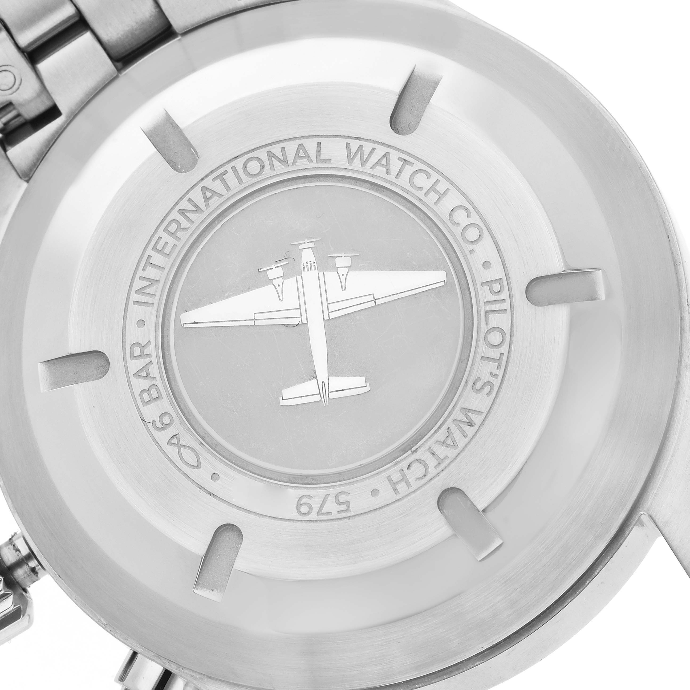 The image shows the case back of an IWC Pilot model men's watch, model number IW377710, featuring an airplane engraving and brand markings.
