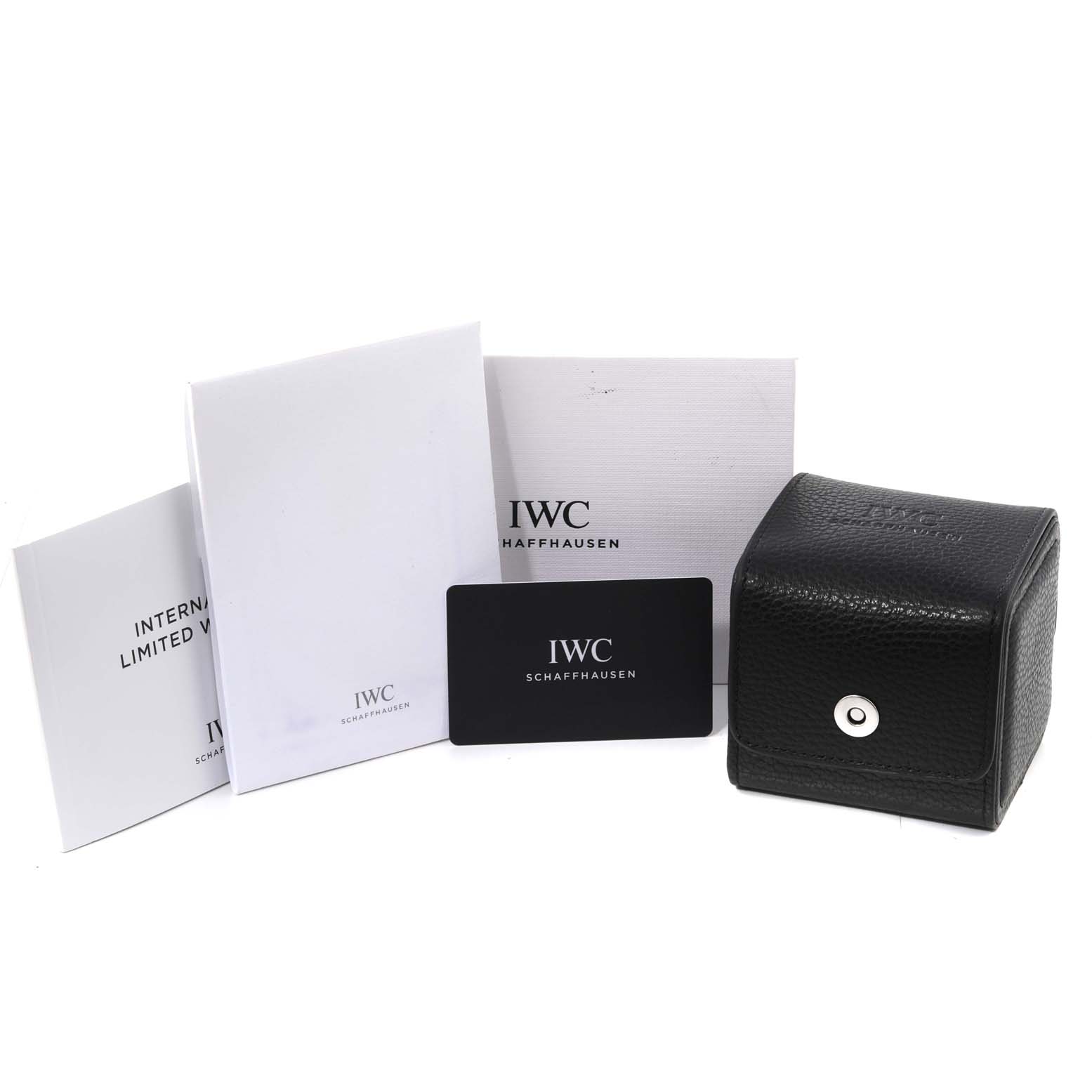 The image shows the packaging and accessories for an IWC Pilot IW327006 Men's Titanium Black Dial IW327006 Men's Titanium Black Dial model watch, including boxes, booklets, and a warranty card.