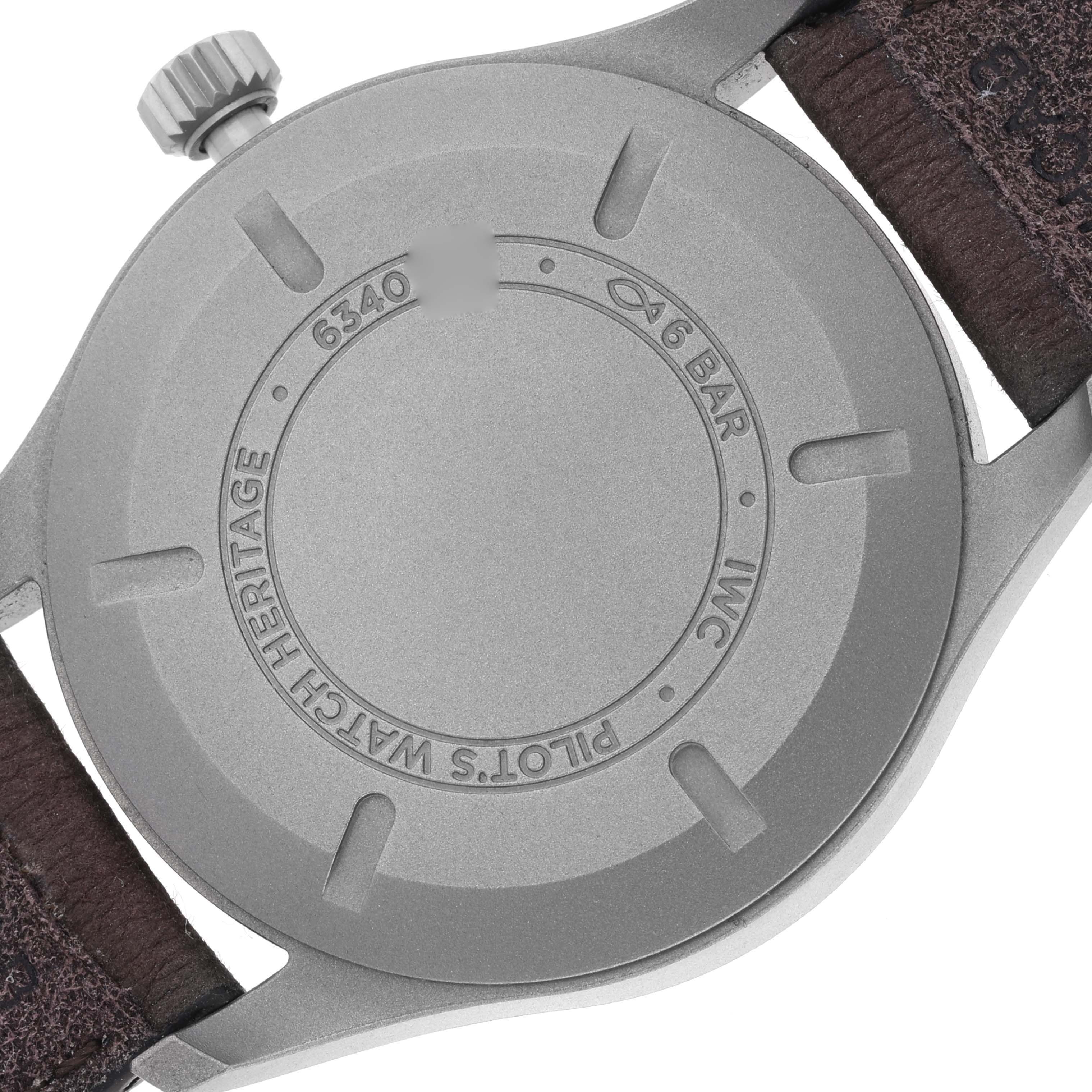 The image shows the back case and strap of an IWC Pilot IW327006 Men's Titanium Black Dial IW327006 Men's Titanium Black Dial model watch, highlighting its screw-down case back and textured strap.