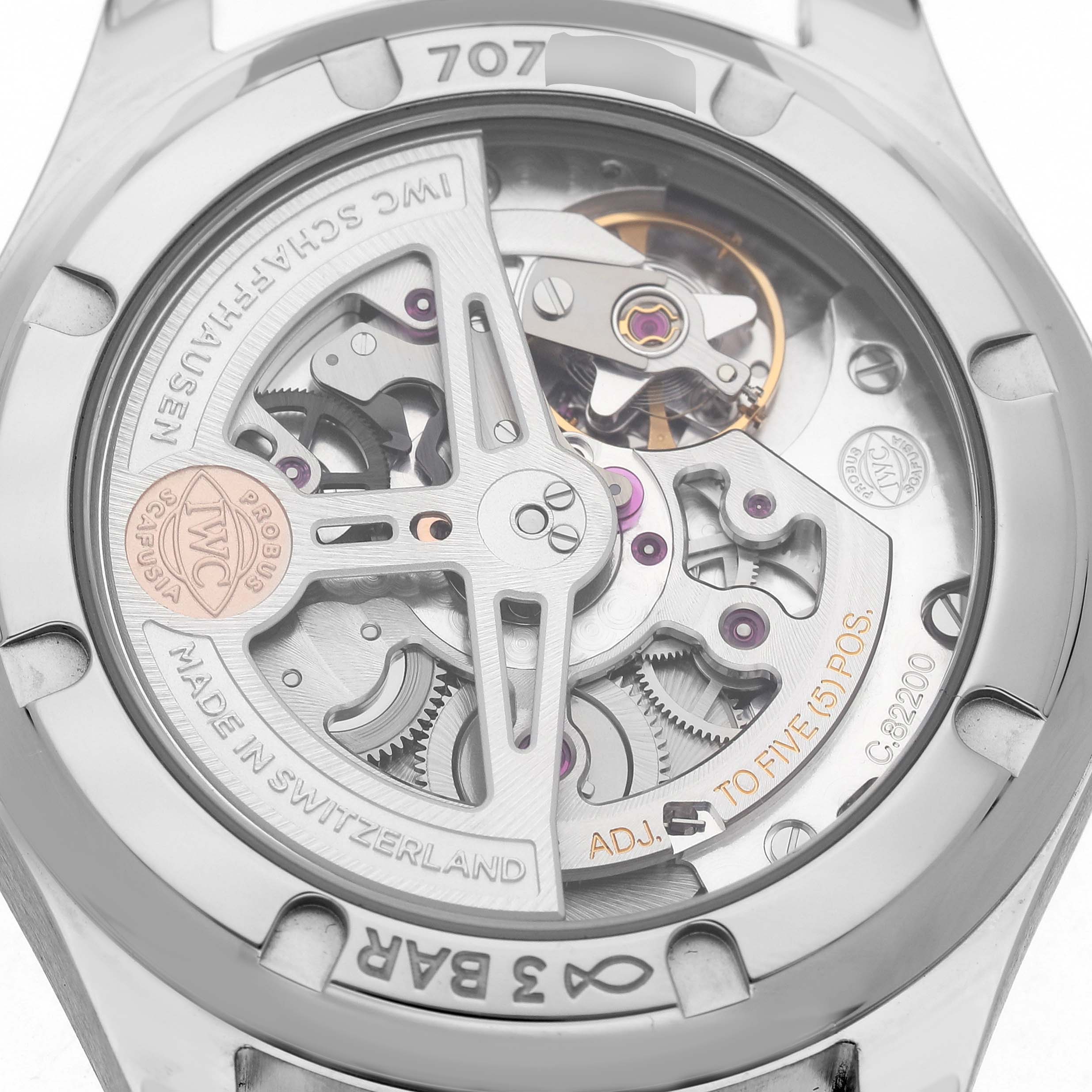 The image shows the back side of an IWC Portuguese IW358304 Men's Stainless Steel Silver Dial watch, displaying its intricate mechanical movement.