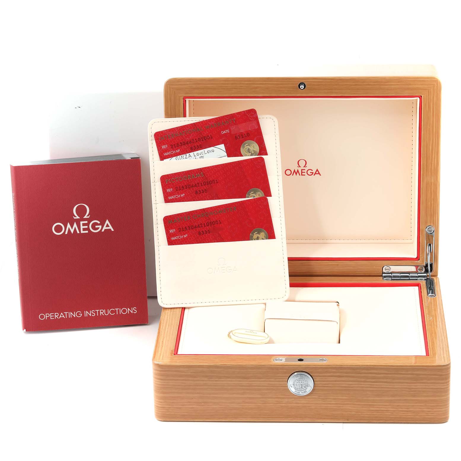 This image shows the packaging and accessories for an Omega Planet Ocean 215.30.44.21.01.001 Men
s Stainless Steel Black Dial 215.30.44.21.01.001 Men
s Stainless Steel Black Dial watch, including the box, instruction book, and warranty cards.