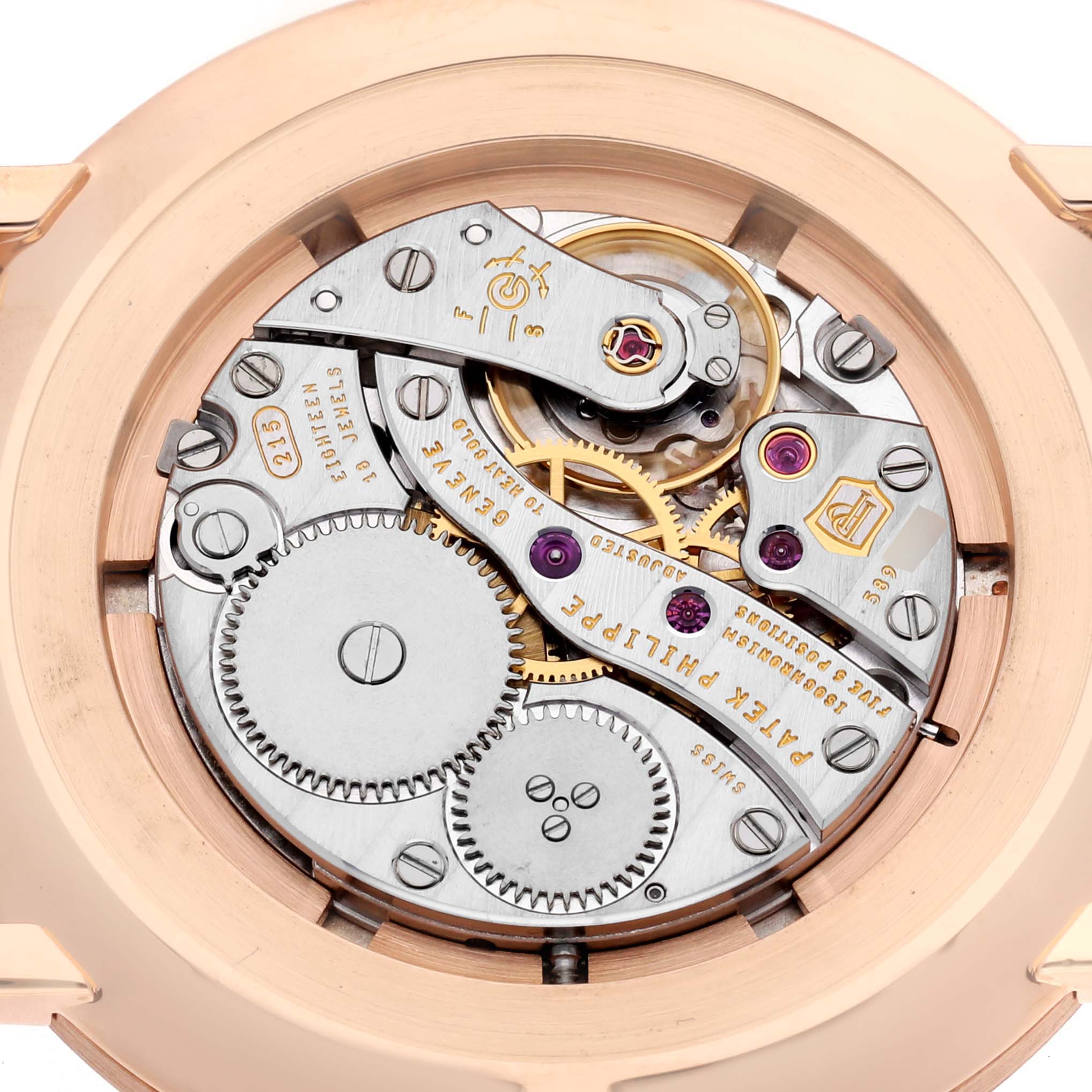 The image shows a close-up view of the mechanical movement of a Patek Philippe Calatrava, model 5116R, showcasing the intricate gears and components.