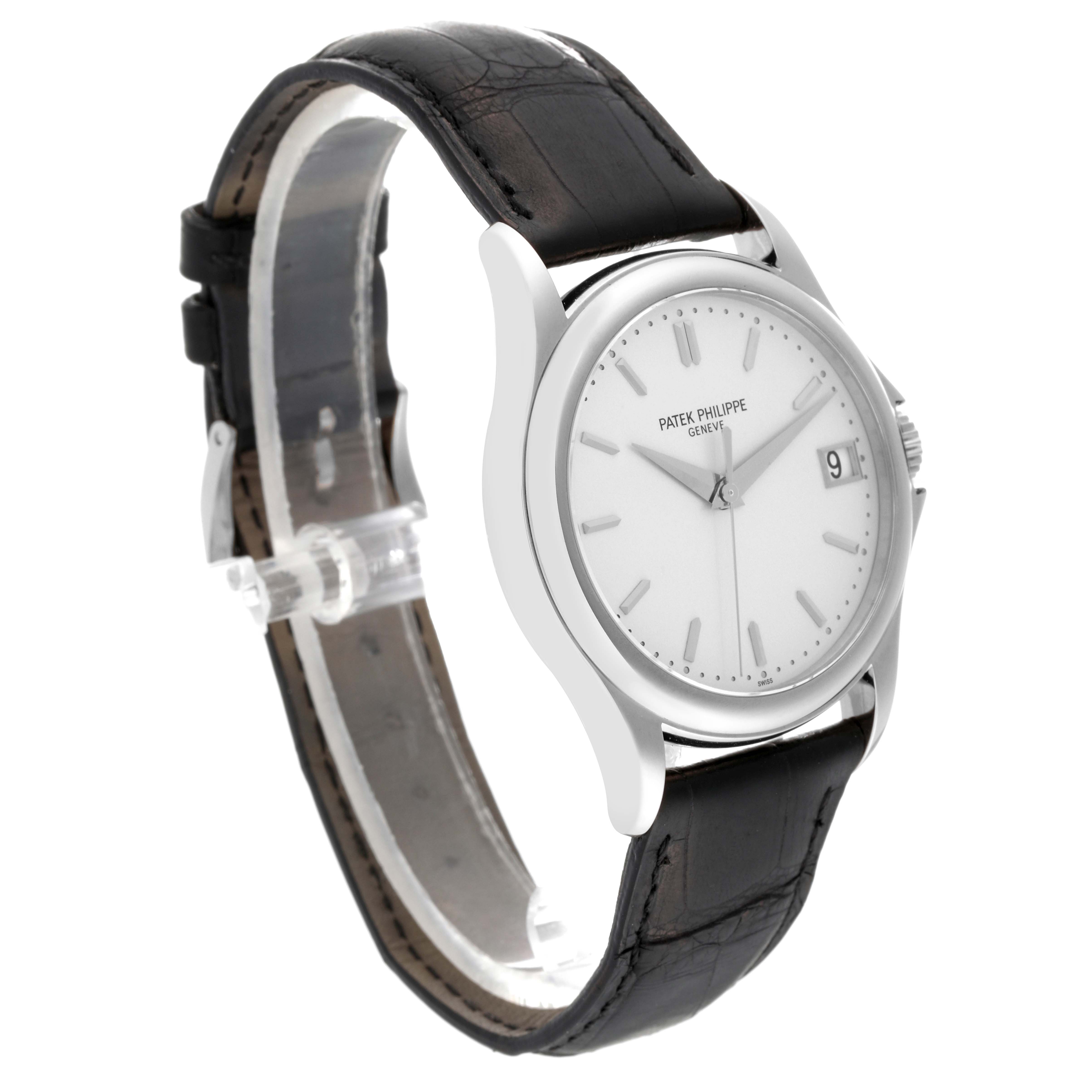 The image shows a Patek Philippe Calatrava 5127G-001 Men's White Gold Silver Dial 5127G-001 Men's White Gold Silver Dial watch at a three-quarter angle, highlighting its face and black leather strap.
