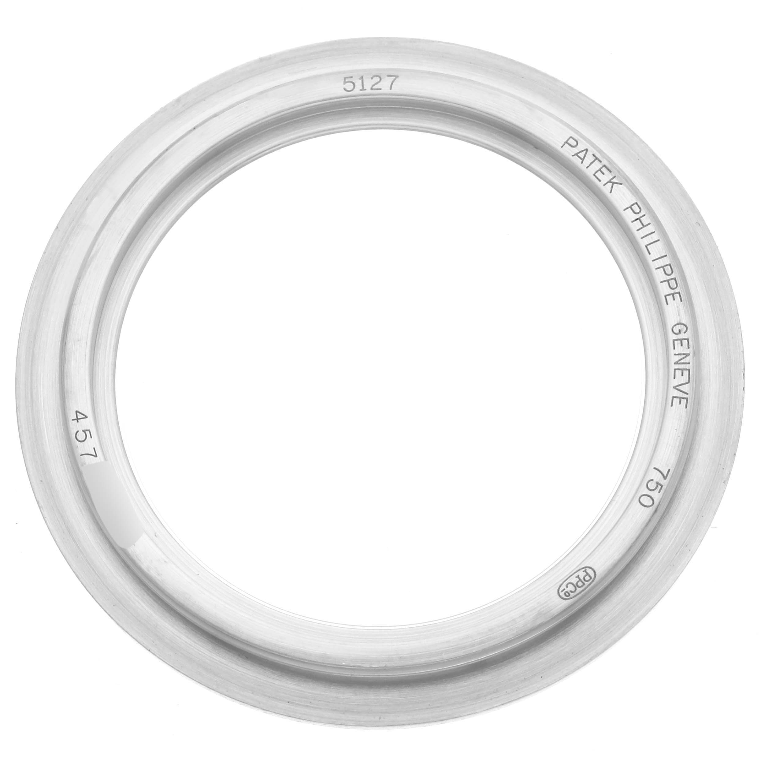 This image shows the bezel of a Patek Philippe Calatrava 5127G-001 Men's White Gold Silver Dial 5127G-001 Men's White Gold Silver Dial model, with the brand name and specifications engraved.