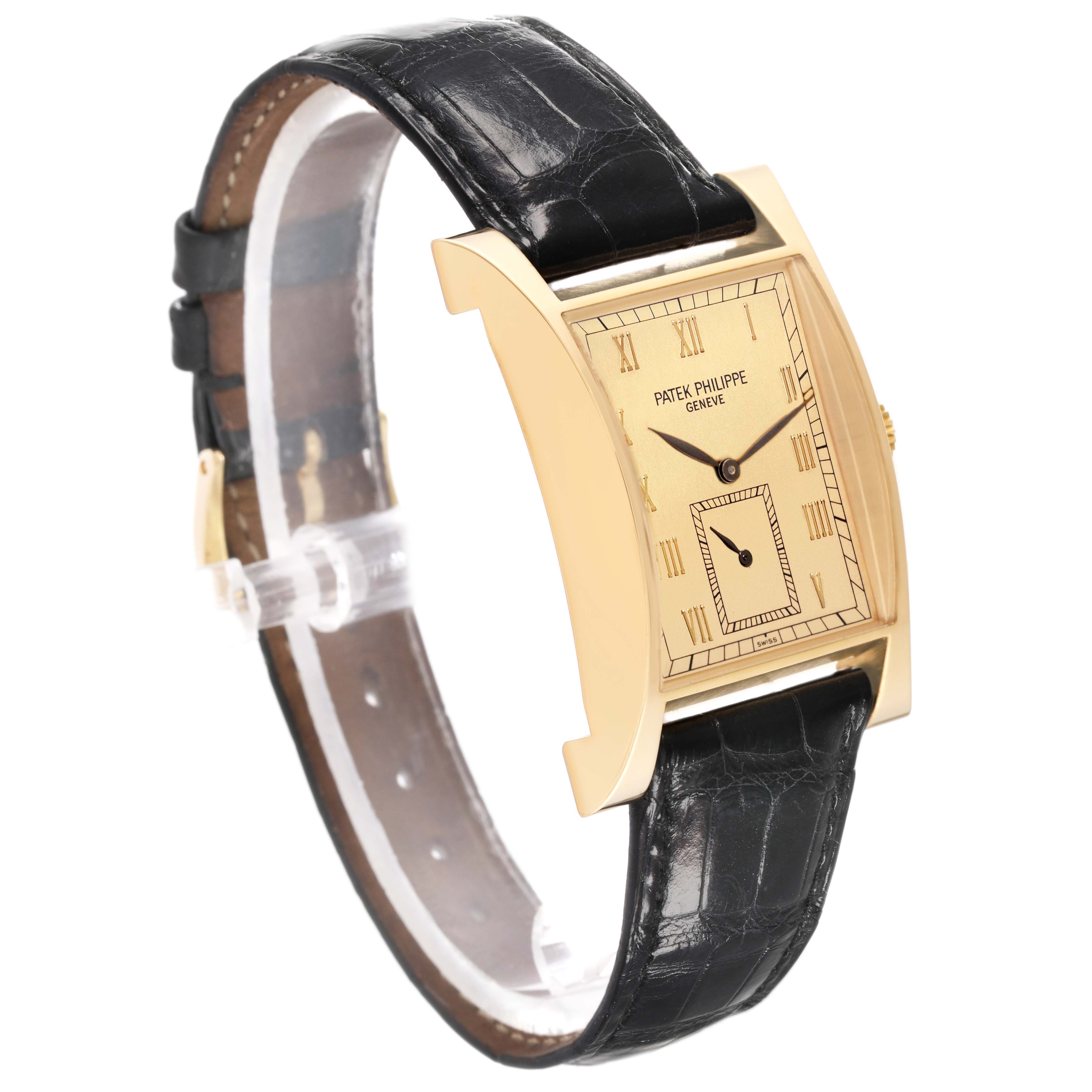 The Patek Philippe Pagoda 5500J Men's Yellow Gold Champagne Dial 5500J Men's Yellow Gold Champagne Dial watch is shown at an angled side view, highlighting its rectangular gold case, dial, and black leather strap.