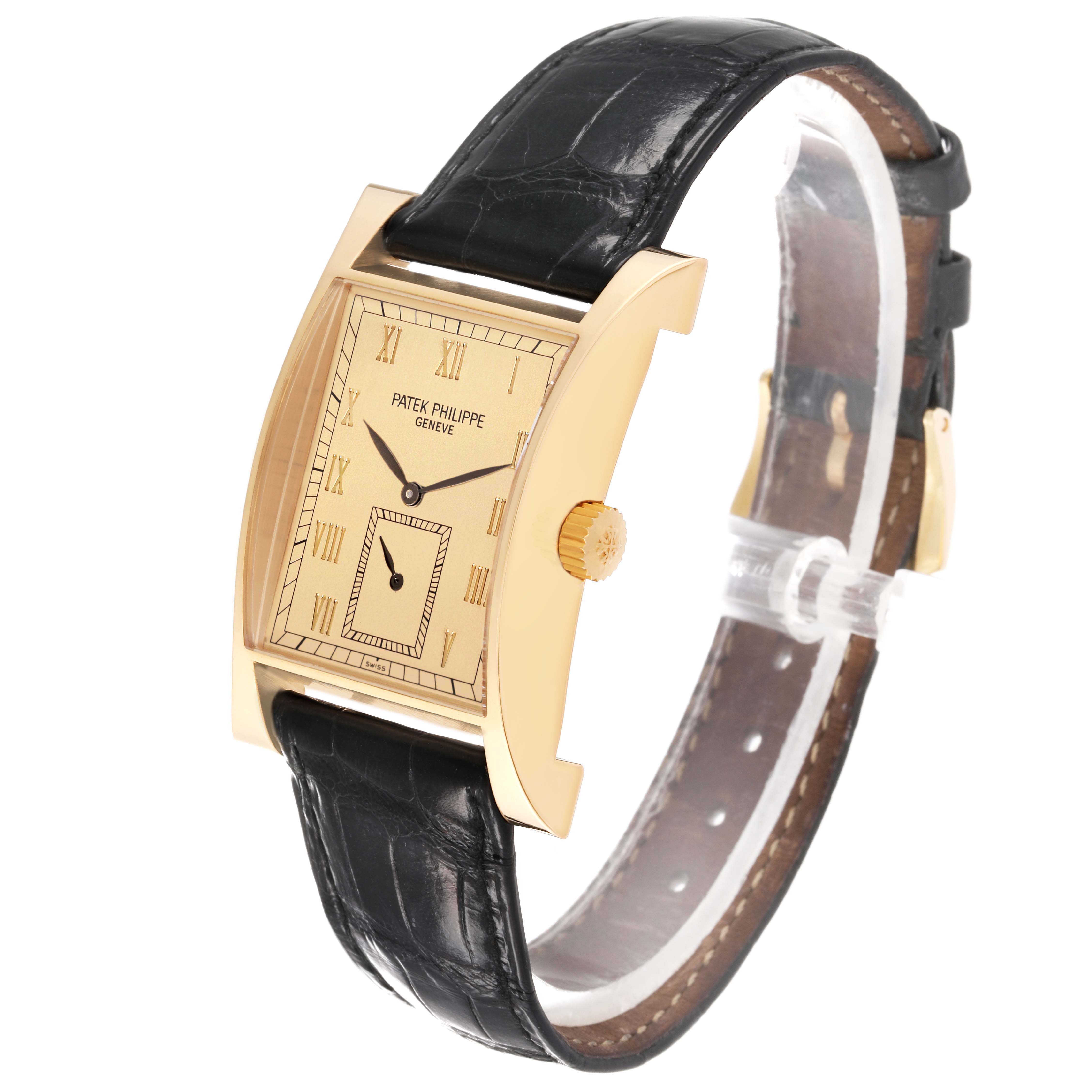 The Patek Philippe Pagoda 5500J Men's Yellow Gold Champagne Dial 5500J Men's Yellow Gold Champagne Dial watch is shown at a slight angle, displaying its rectangular gold case and black leather strap.