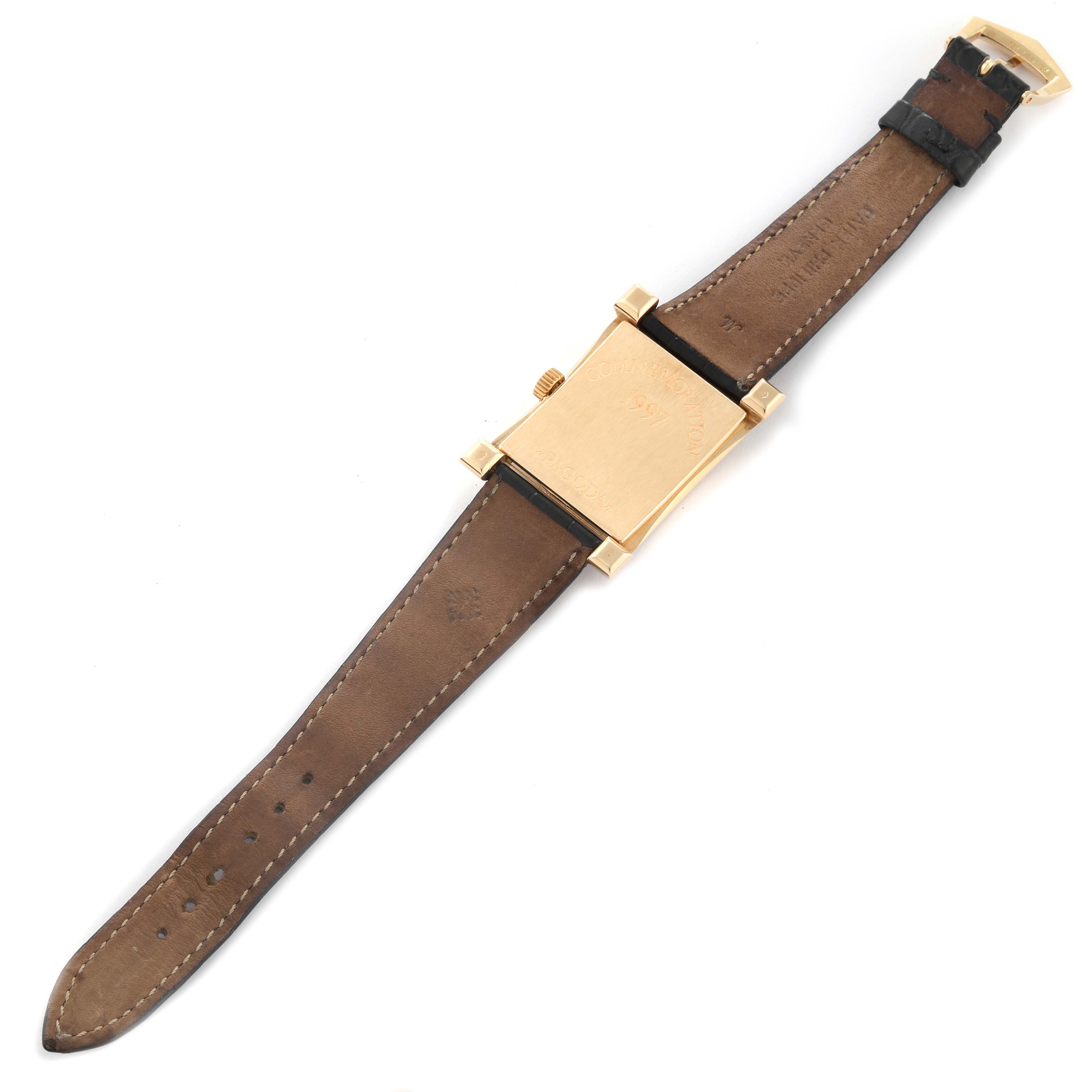 This is a Pagoda model watch by Patek Philippe, shown from the back with a brown leather strap and gold rectangular case.