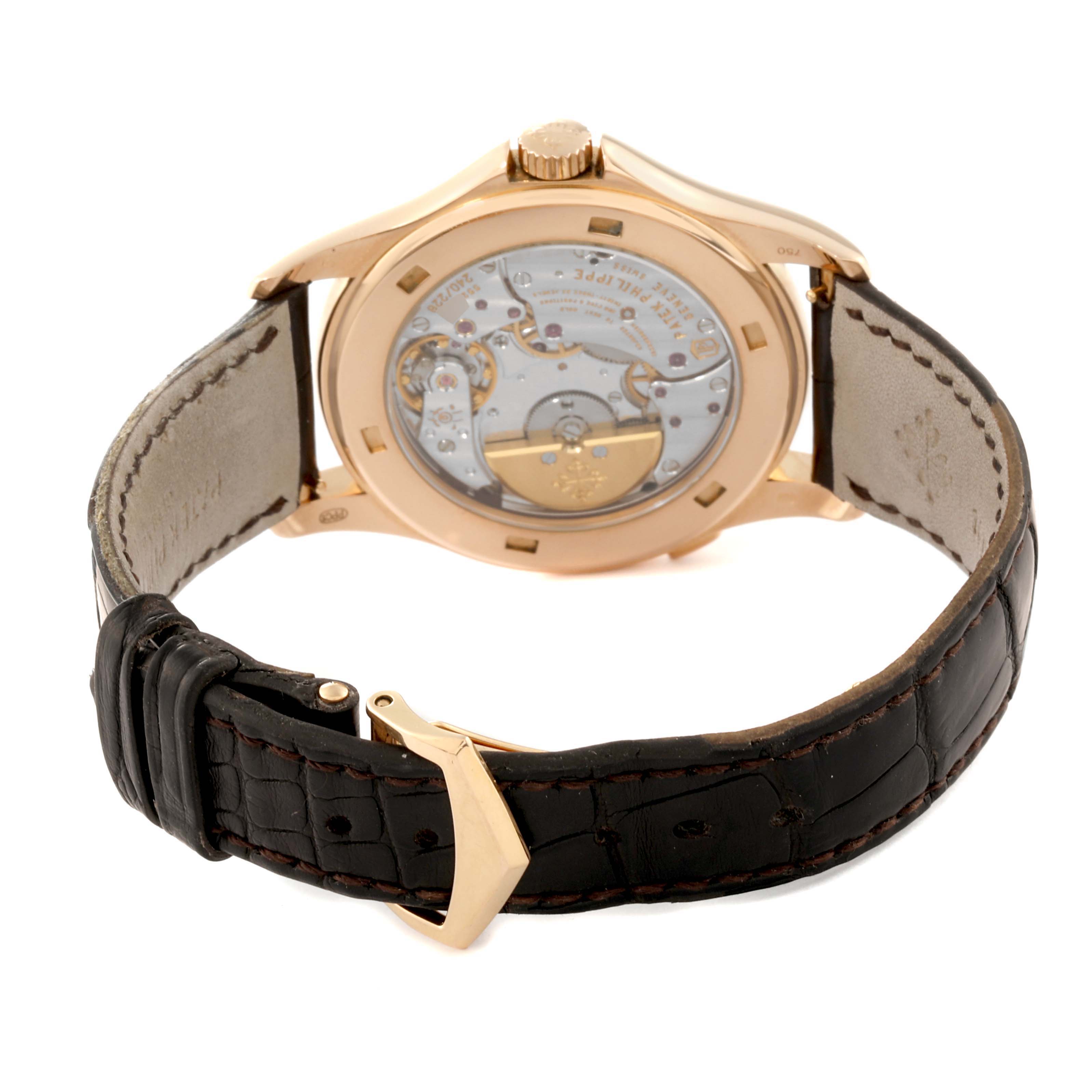 The image shows the back view of the Patek Philippe Complications 5130R-001 Men
s Rose Gold Silver Dial 5130R-001 Men
s Rose Gold Silver Dial watch, showcasing its movement and leather strap.