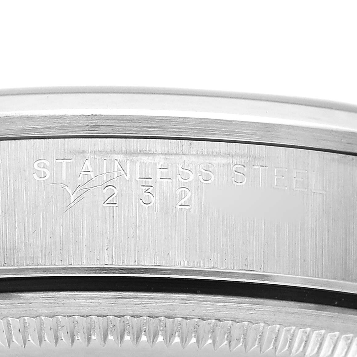 This image shows a close-up of the engraved side of a stainless steel Rolex Air-King 14000 Men's Stainless Steel Black Dial watch bezel.