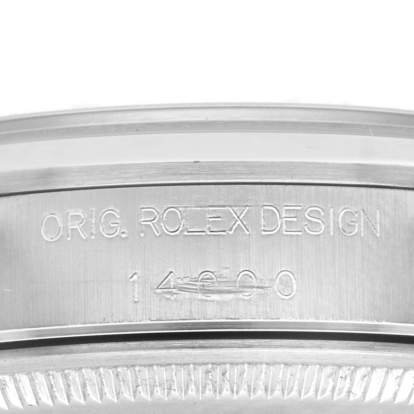 This image shows an engraving on the side of the bezel of a Rolex Air-King 14000 Men's Stainless Steel Black Dial 14000 Men's Stainless Steel Black Dial watch, displaying the words "ORIG. ROLEX DESIGN" and the model number "14000."
