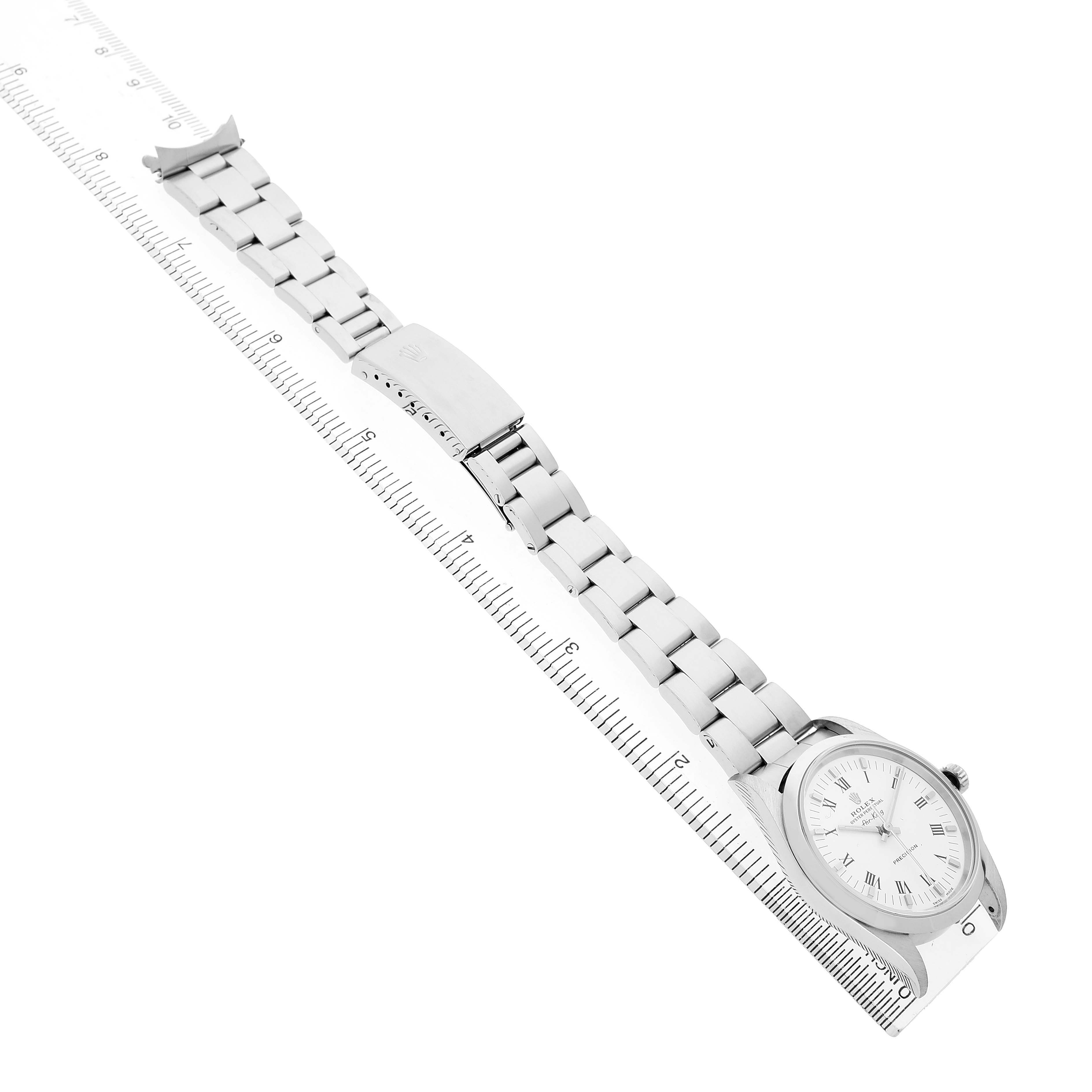 The Rolex Air-King 14000 Men's Stainless Steel White Dial watch is shown at a high angle with a view of the face, bracelet, and clasp alongside a ruler.