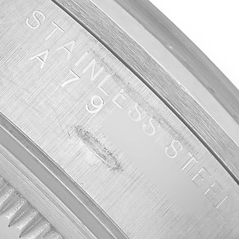 The image shows a close-up of the engraved "STAINLESS STEEL" text on the edge of a Rolex Air-King 14000 Men's Stainless Steel White Dial watch case.