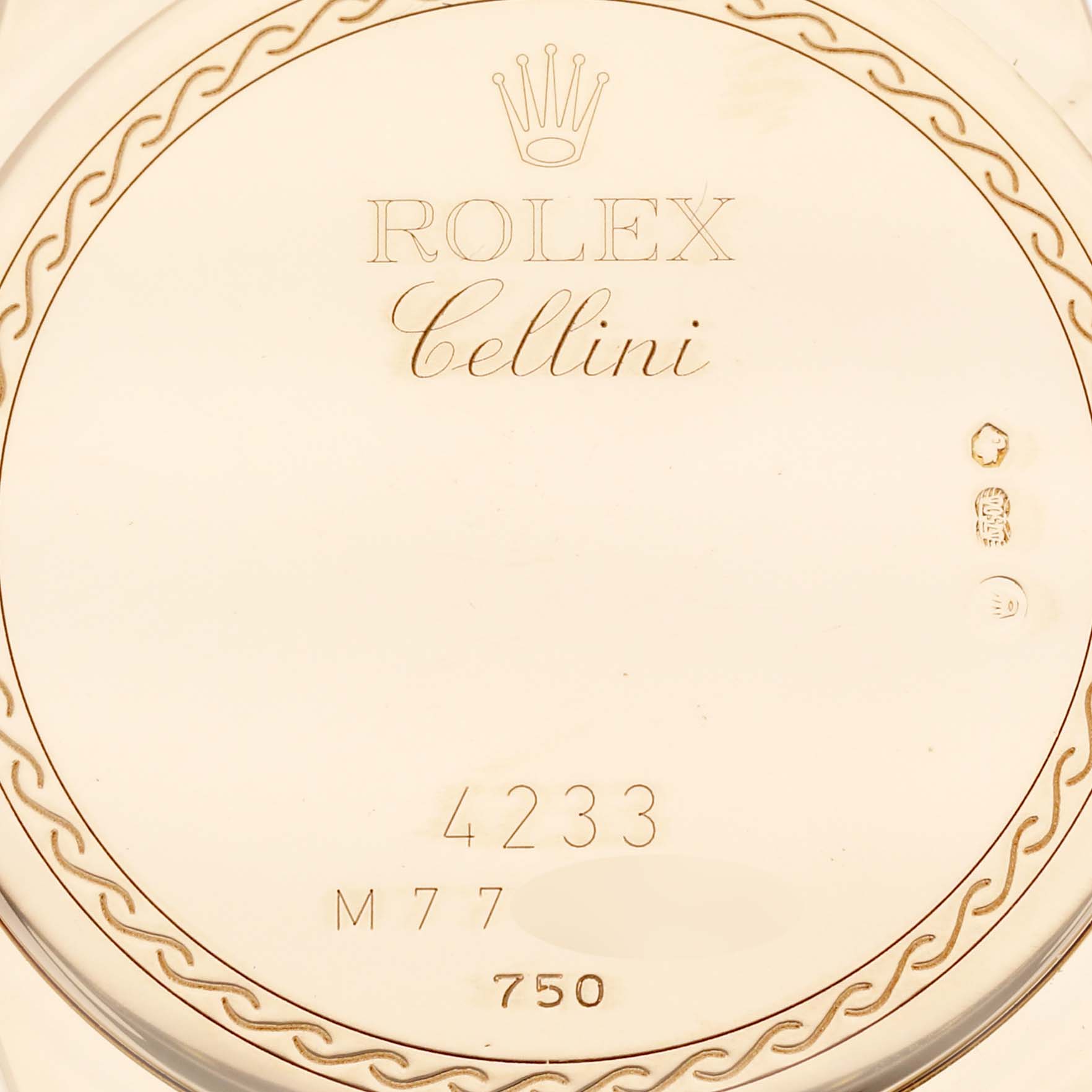 This image shows a close-up of the back case of a Rolex Cellini 4233/8 Men's Yellow Gold Black Dial 4233/8 Men's Yellow Gold Black Dial watch, featuring engravings and hallmarks.