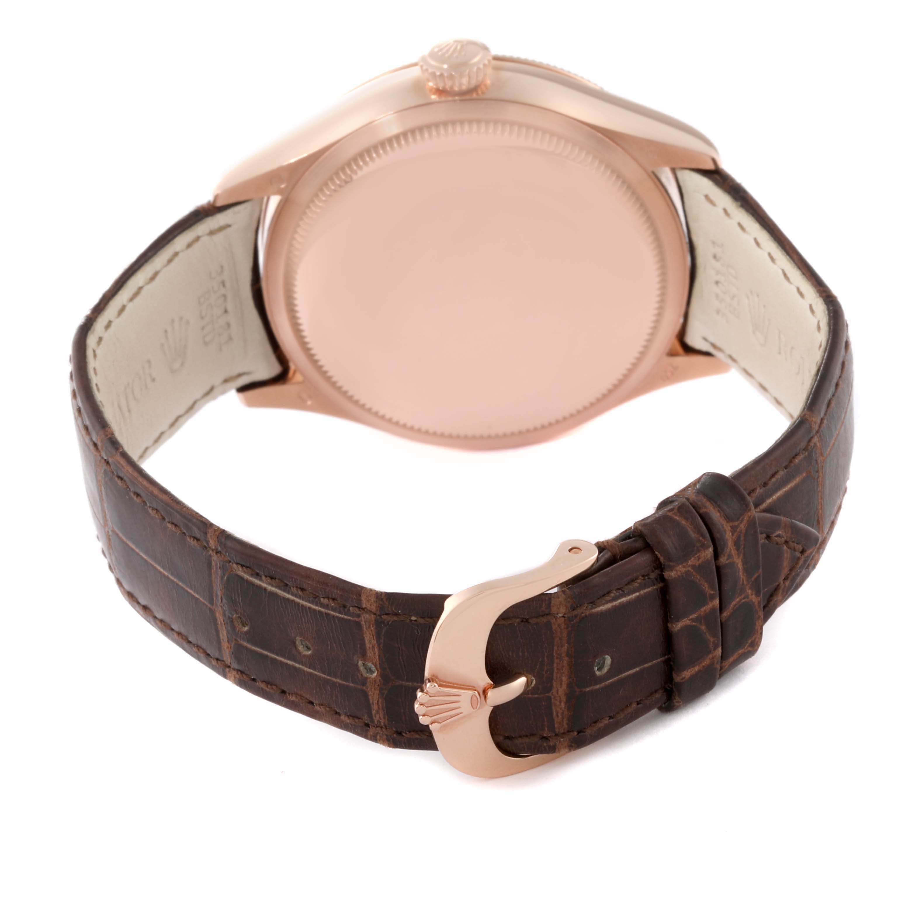 The image shows the back of a Rolex Cellini 50525 Men's Rose Gold Silver Dial 50525 Men's Rose Gold Silver Dial watch along with its brown leather strap and clasp.