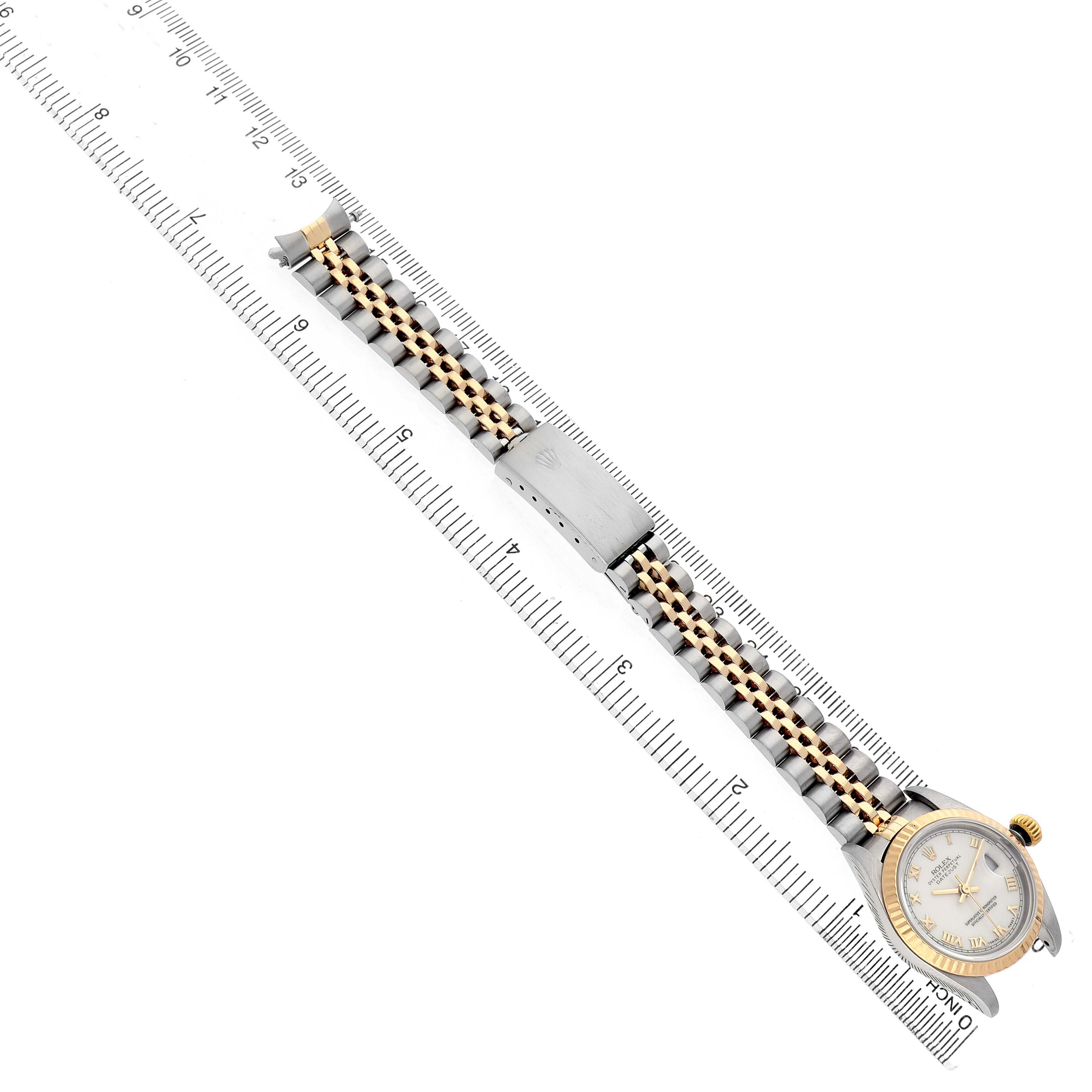 The Rolex Datejust 79173 Women's Steel and Gold (two tone) White Dial watch is shown from a top-down angle, highlighting the face, bezel, and full bracelet.