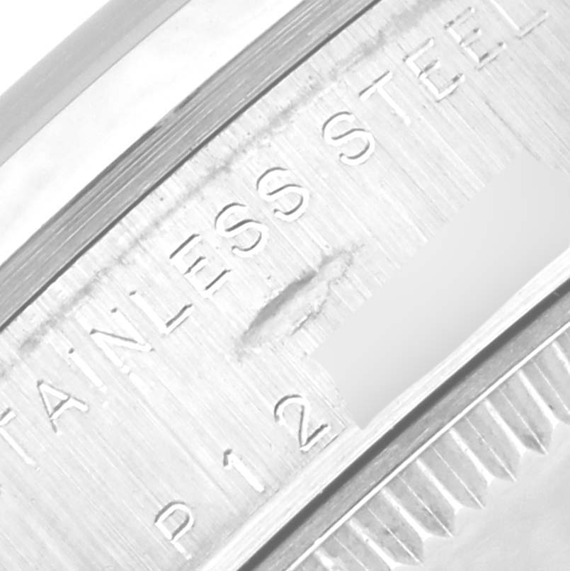 The image shows a close-up of the case back engraving on a Rolex Mid-Size 78240 Women's Stainless Steel Pink Dial 78240 Women's Stainless Steel Pink Dial watch, highlighting the "STAINLESS STEEL" marking.
